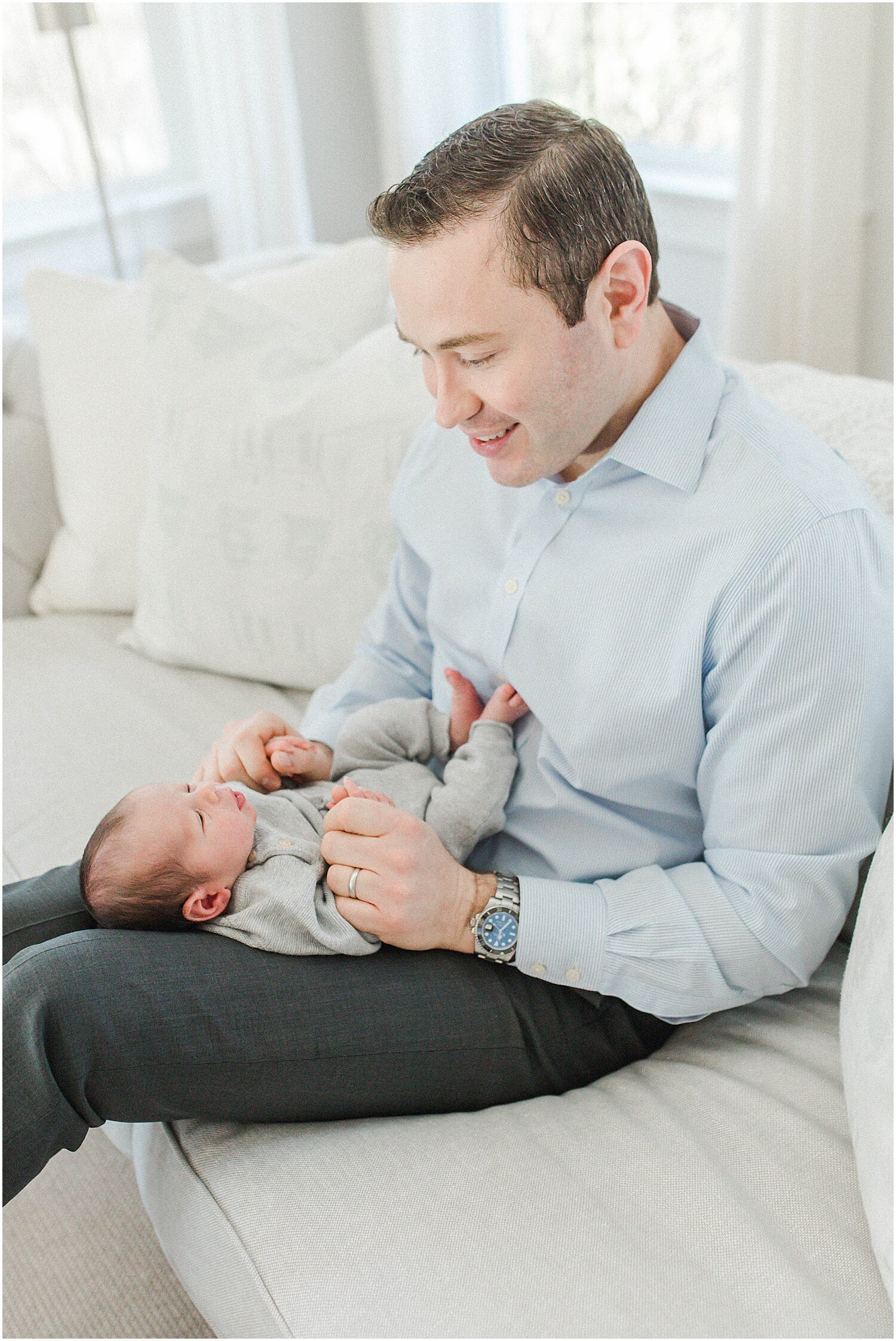 Father and son lifestyle newborn photos during newborn photoshoot. Photos by Kristin Wood Photography.
