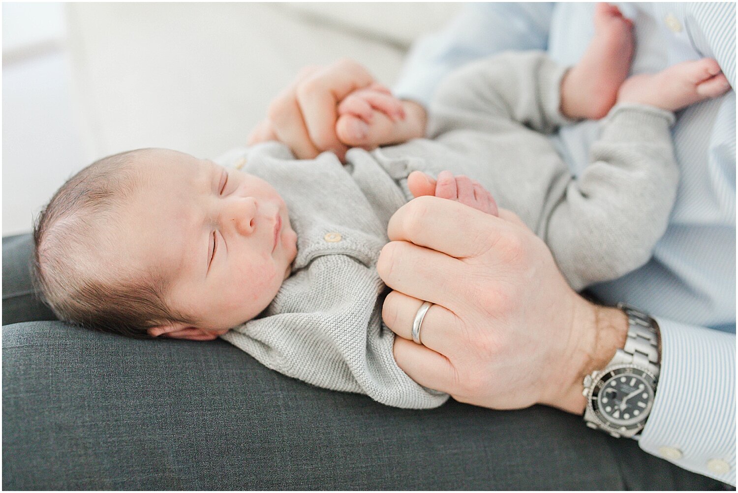 Father and son lifestyle newborn photos during newborn photoshoot. Photos by Kristin Wood Photography.