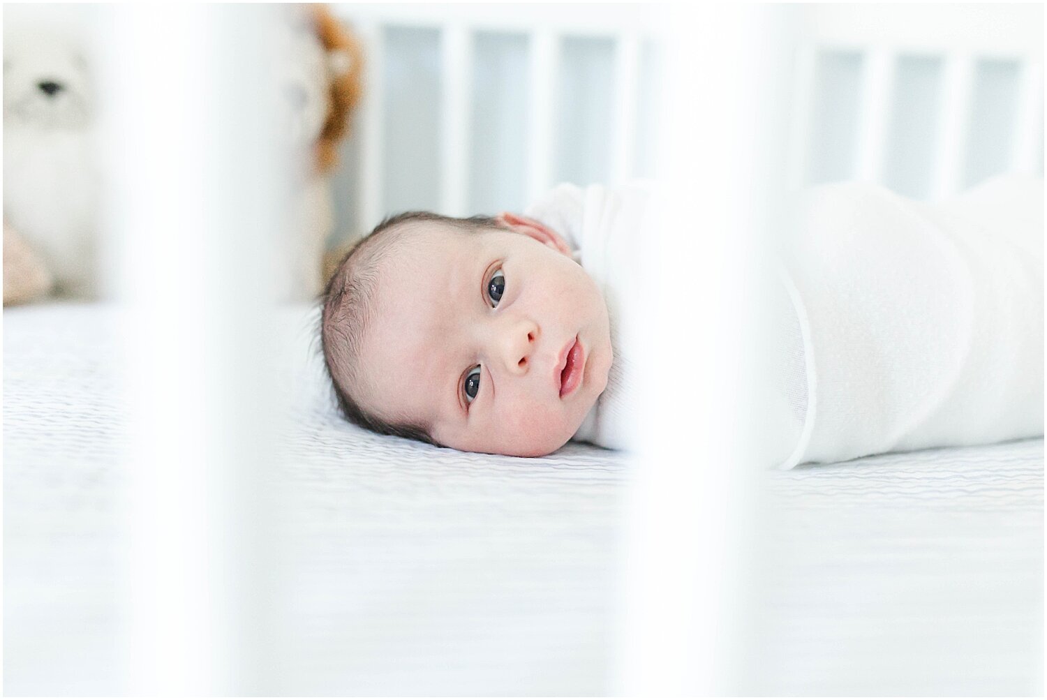 Baby in crib in beautiful nursery in Westport, CT. Photos by Kristin Wood Photography.