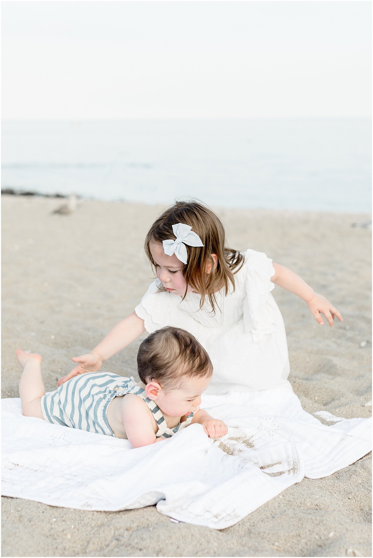 Brother and sister at Sherwood Island in Westport, CT during family photoshoot with Kristin Wood Photography.