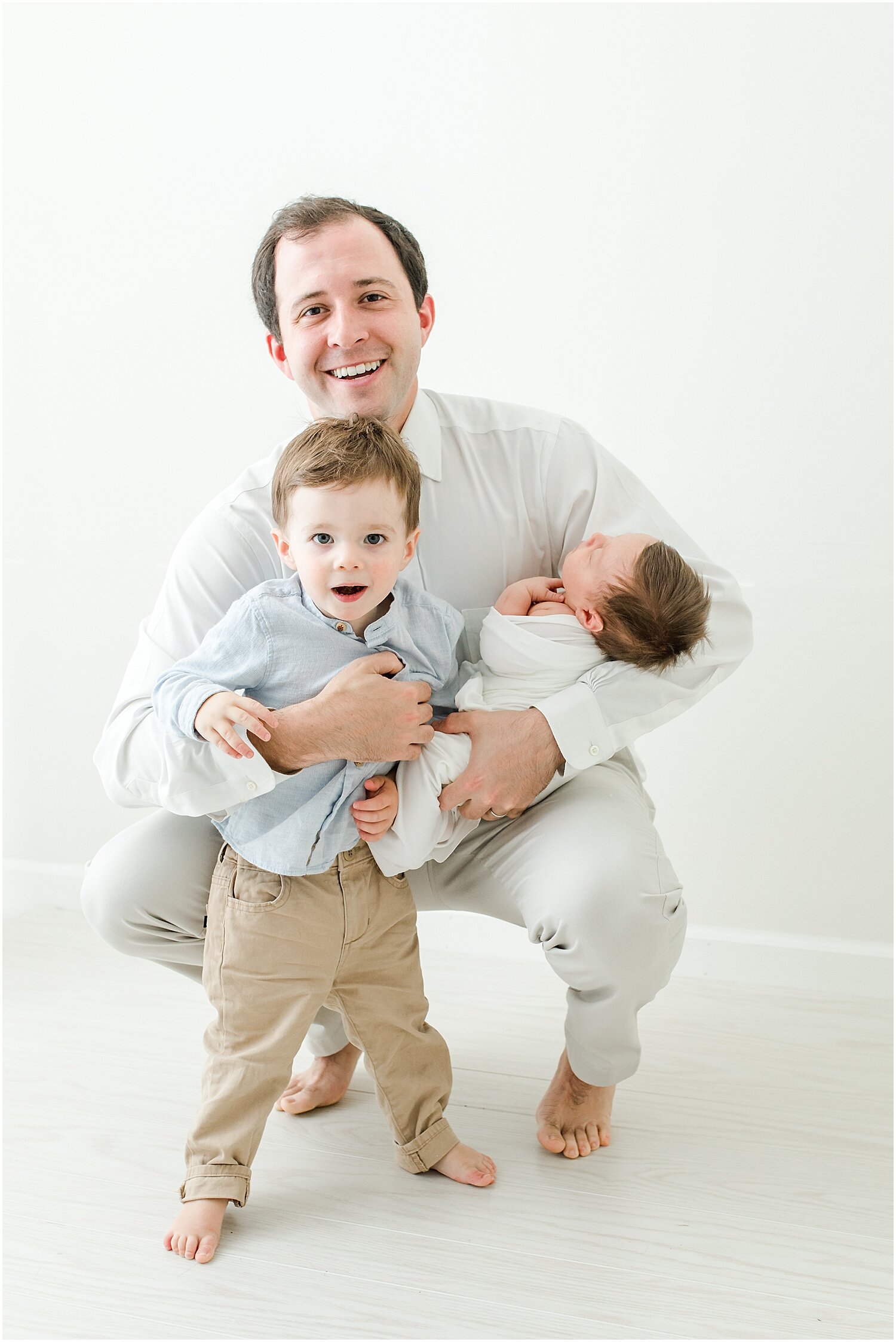 Dad and two boys during Studio Newborn Session by Kristin Wood Photography