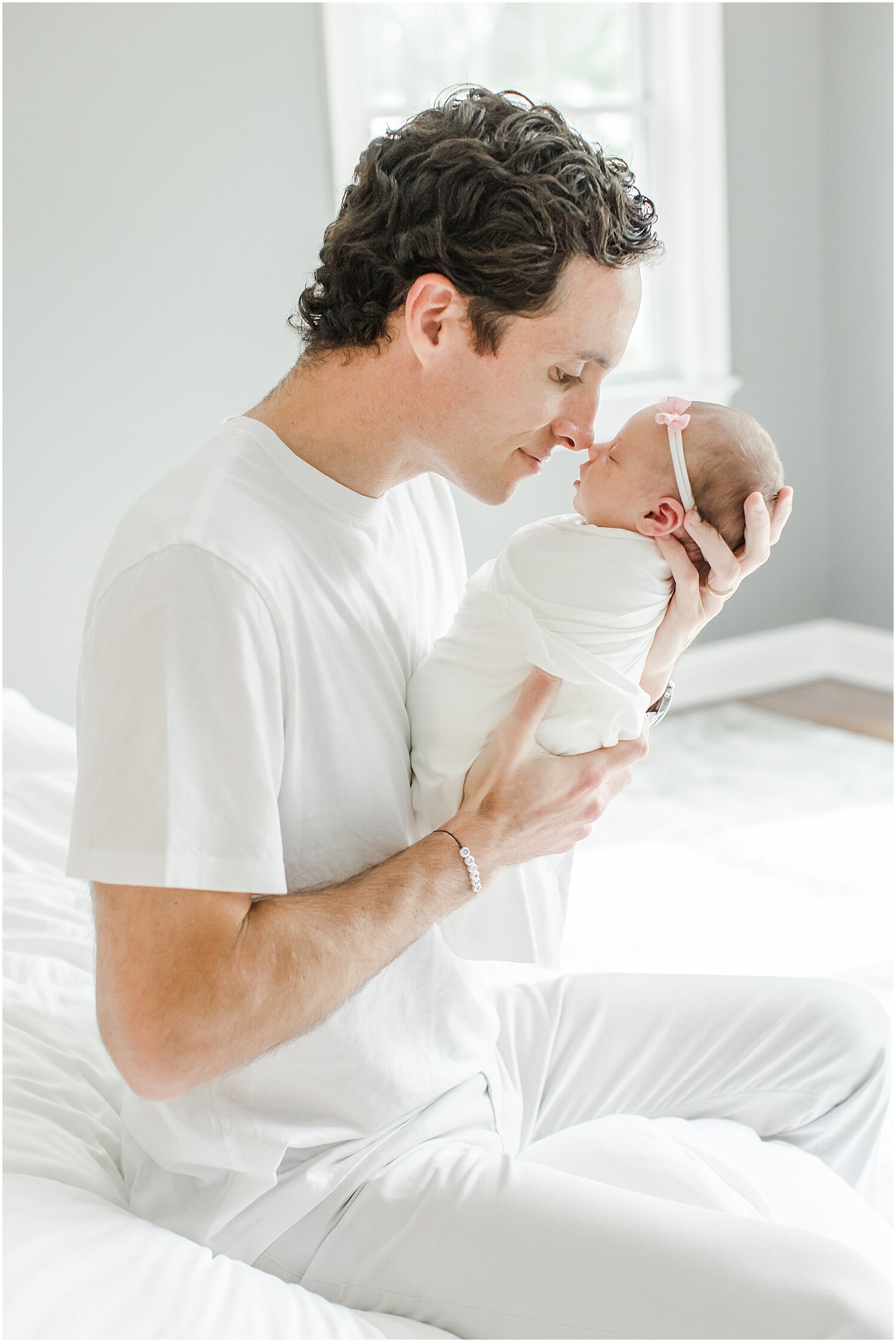 Daddy with his daughter during in-home newborns session. Photos by Kristin Wood Photography. 