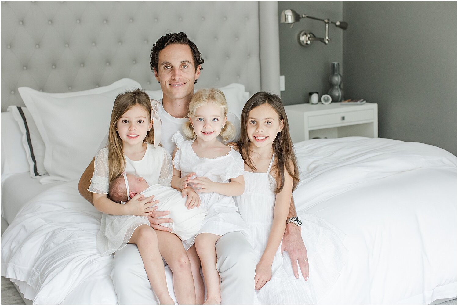 Photo of Daddy and his four girls during lifestyle newborn session. Photos by Rye Newborn Photographer, Kristin Wood Photography.