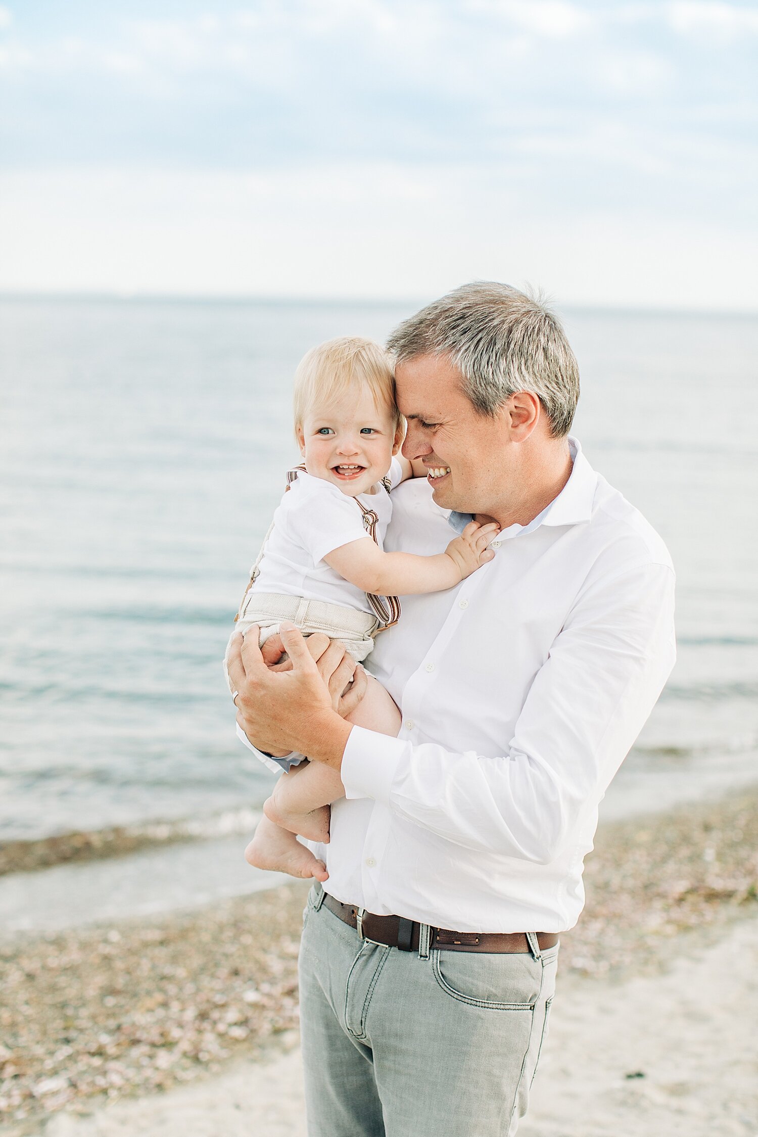 Dad with son on the beach at Sherwood Island. Photos by Kristin Wood Photography.