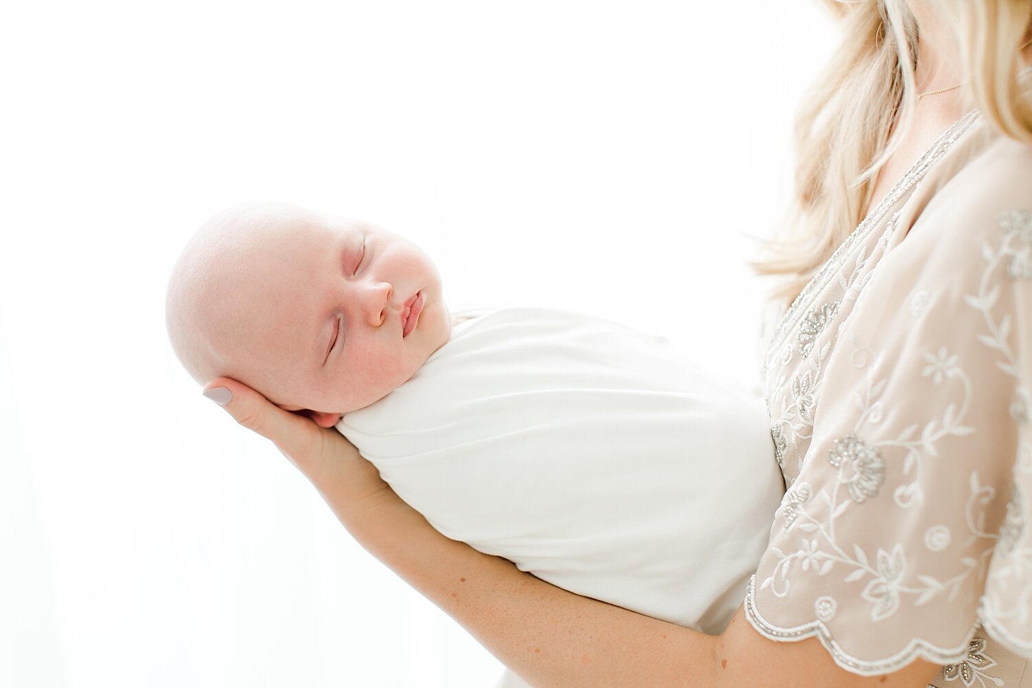 Mom holding baby in her arm | Kristin Wood Photography