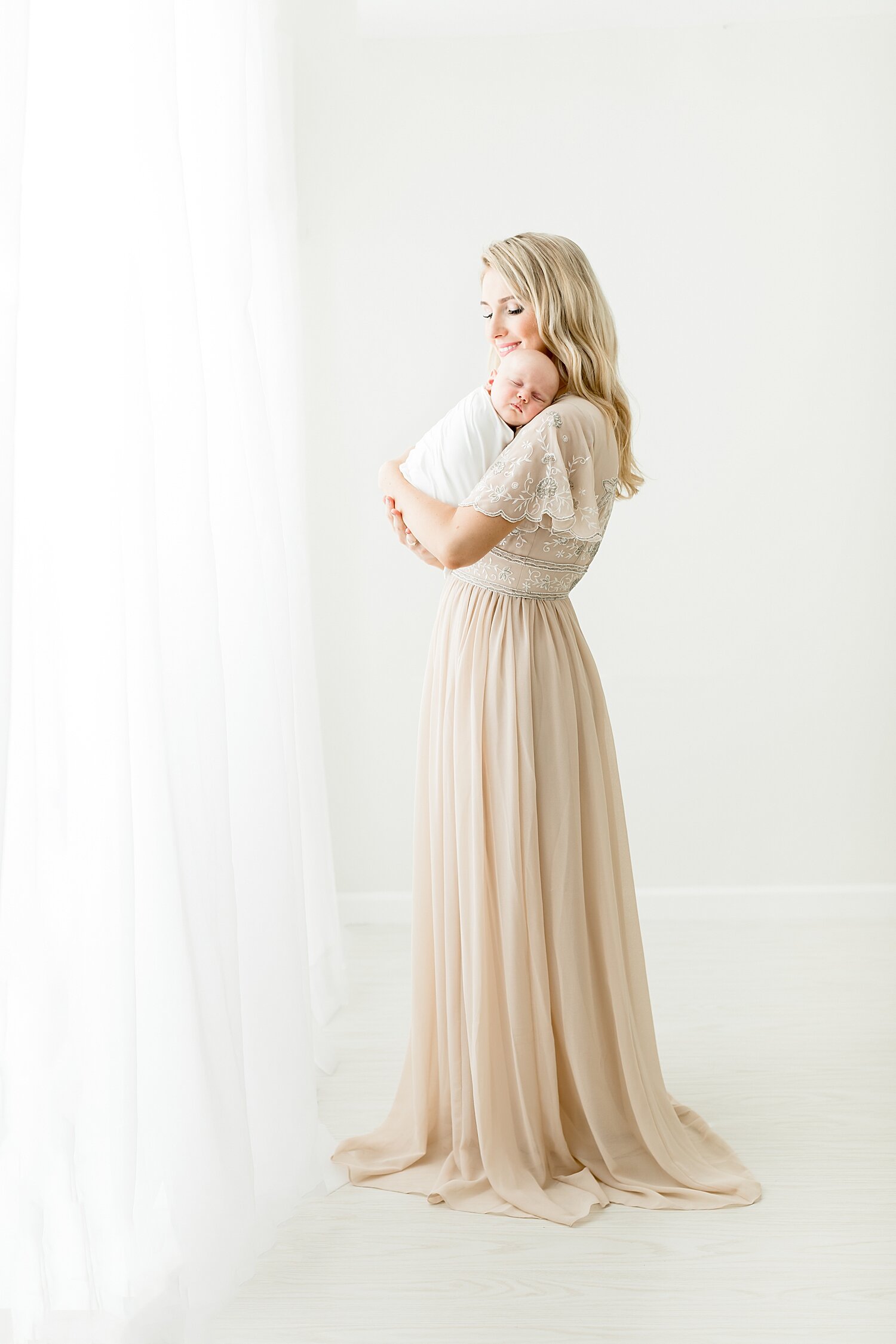 Classic newborn portrait of first time mom holding her baby girl. Photos by Kristin Wood Photography. 