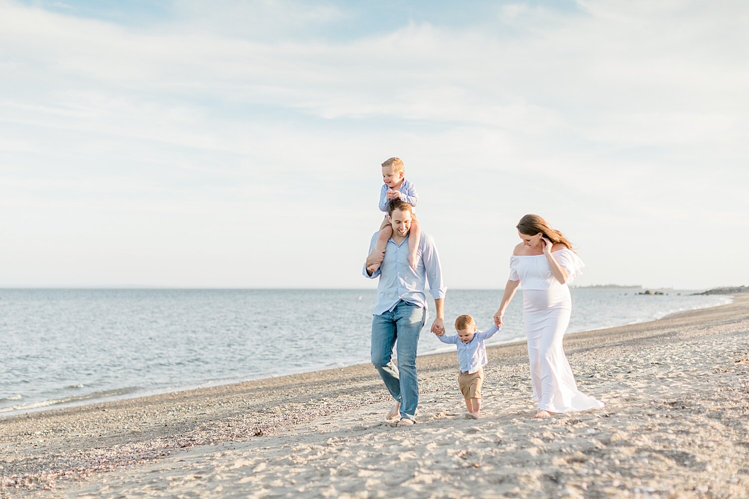 Family walking along the water in Westport, CT. Photos by Kristin Wood Photography.