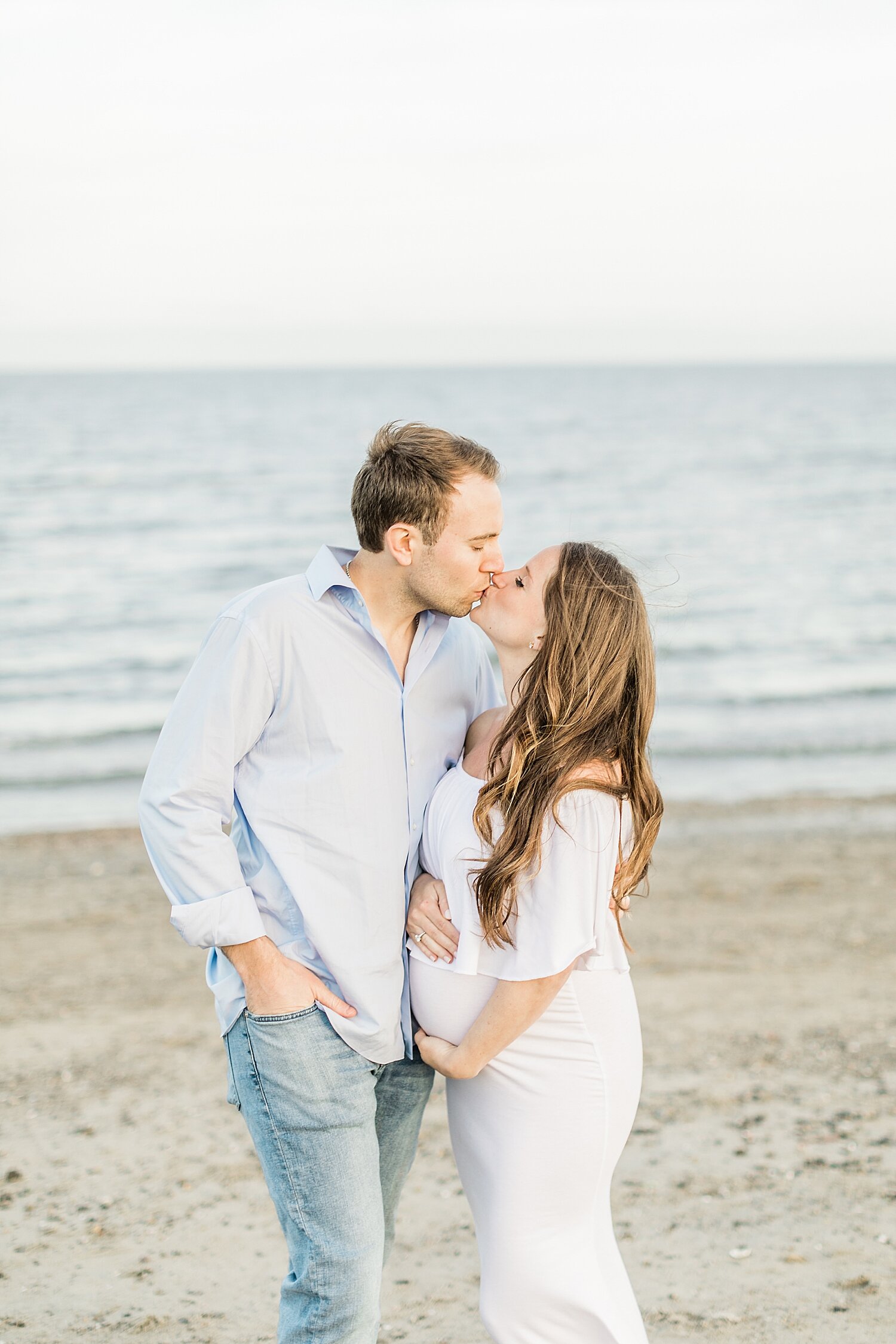 Maternity photo of Mom and Dad kissing. Photos by Westchester County Photographer, Kristin Wood Photography.