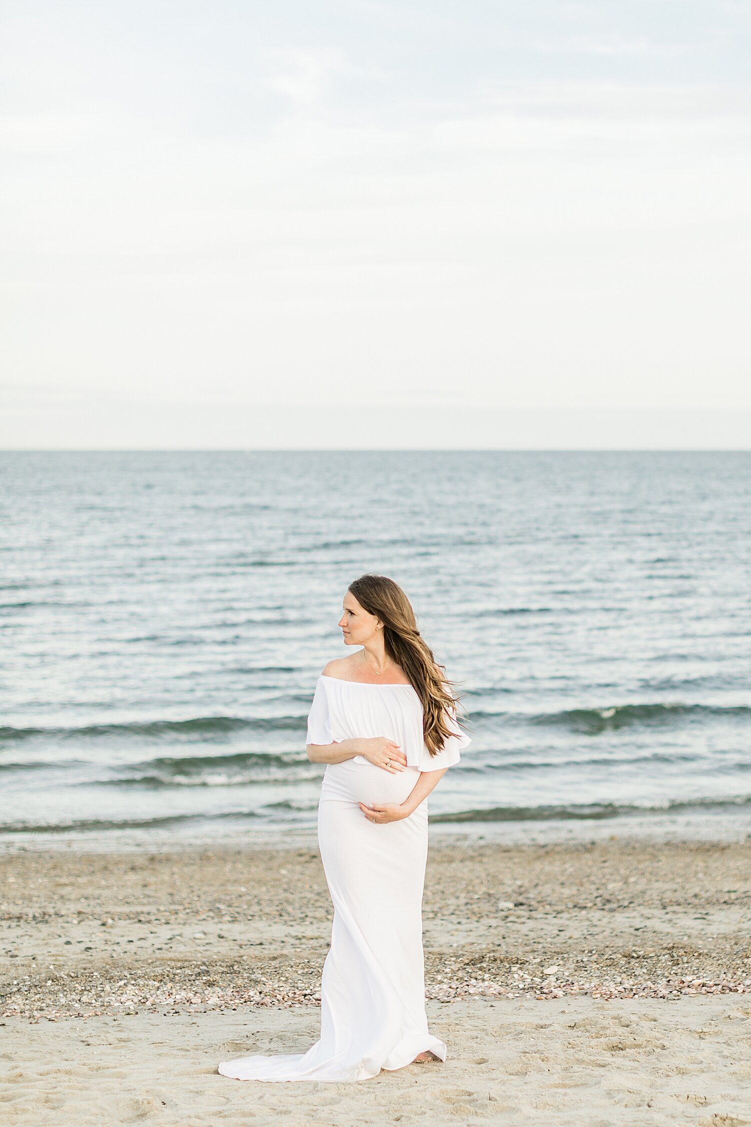 Stunning Mama in white maternity gown at Sherwood Island State Park. Photos by Kristin Wood Photography.
