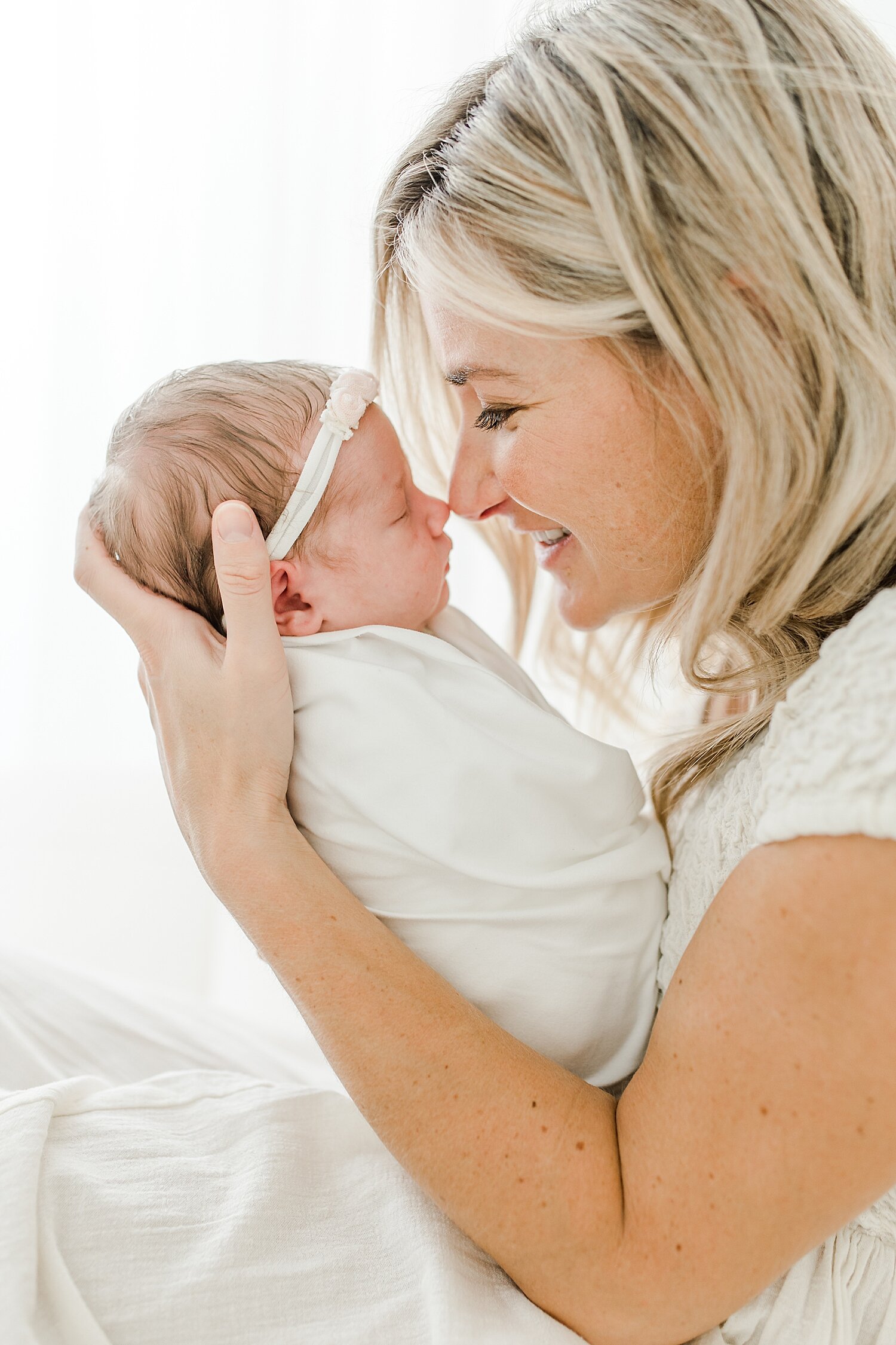 Mom giving baby girl eskimo kisses at newborn session in Darien, CT with Kristin Wood Photography. 