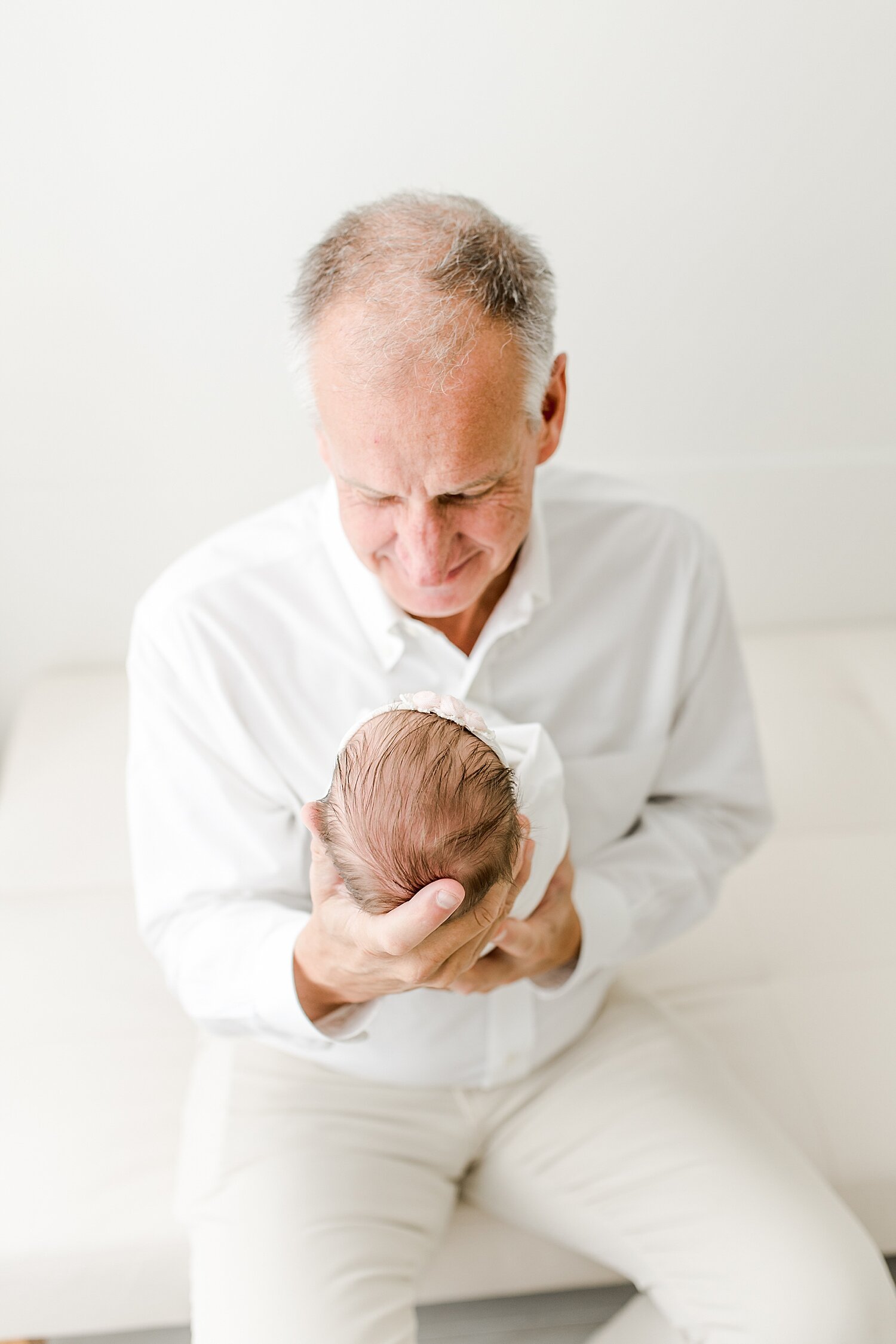 Newborn photo of Daddy with his baby girl. Photos by Kristin Wood Photography.