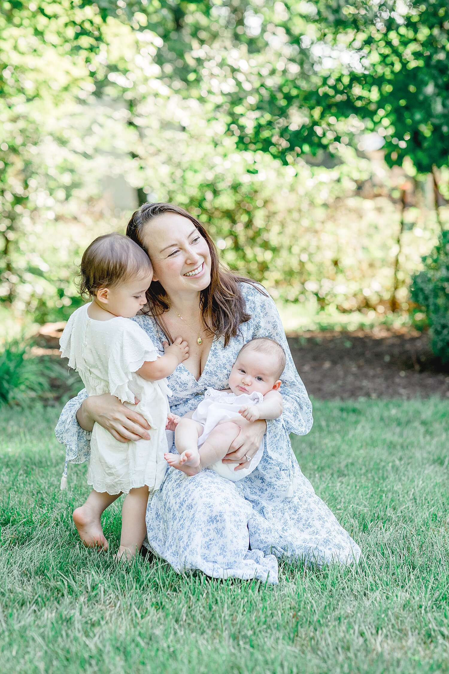 Sweet moment between Mom and her two girls during outdoor newborn session. Photos by Connecticut Newborn Photographer, Kristin Wood Photography.