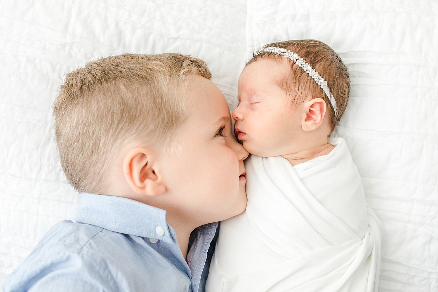 Big brother with his baby sister. Photos by Kristin Wood Photography.