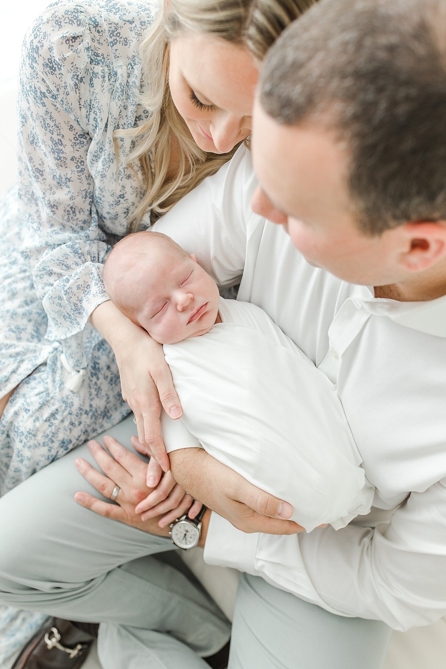 Baby boy swaddled and sleeping on Dad for photos | Kristin Wood Photography