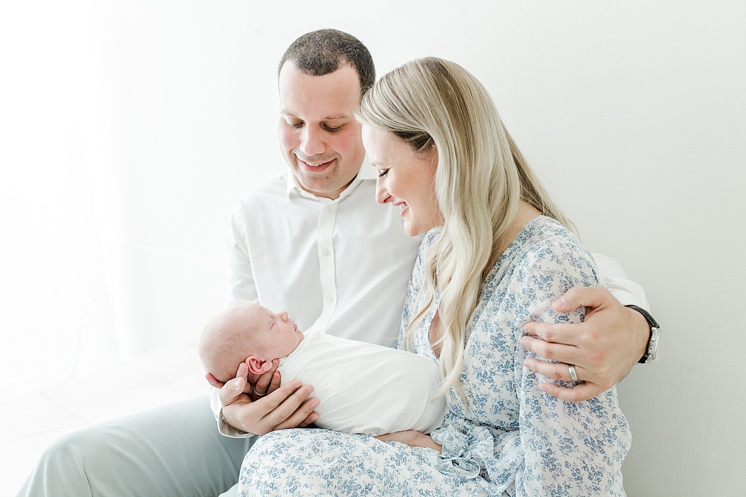 Mom and Dad dressed up for newborn photoshoot in the studio in Darien, CT with Kristin Wood Photography.