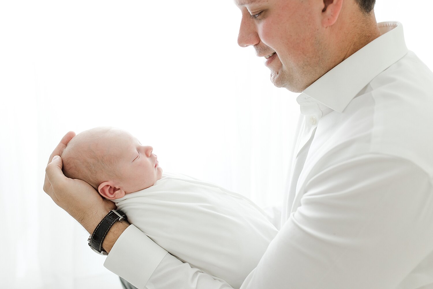 Father and son photo during newborn photoshoot with Kristin Wood Photography.