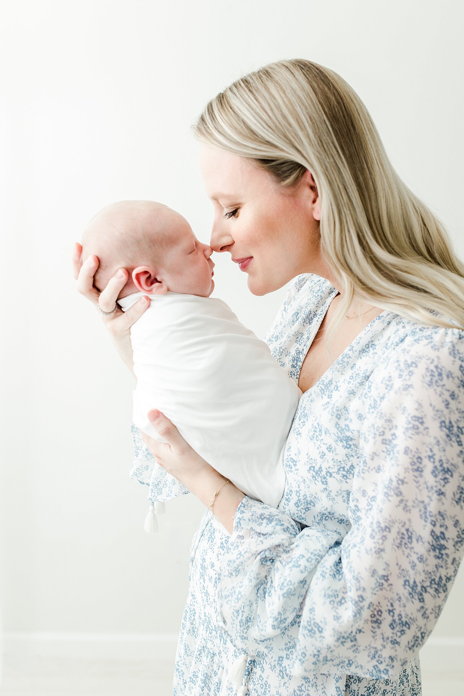 Mom nose to nose with baby boy during newborn session with Kristin Wood Photography in Darien, CT.