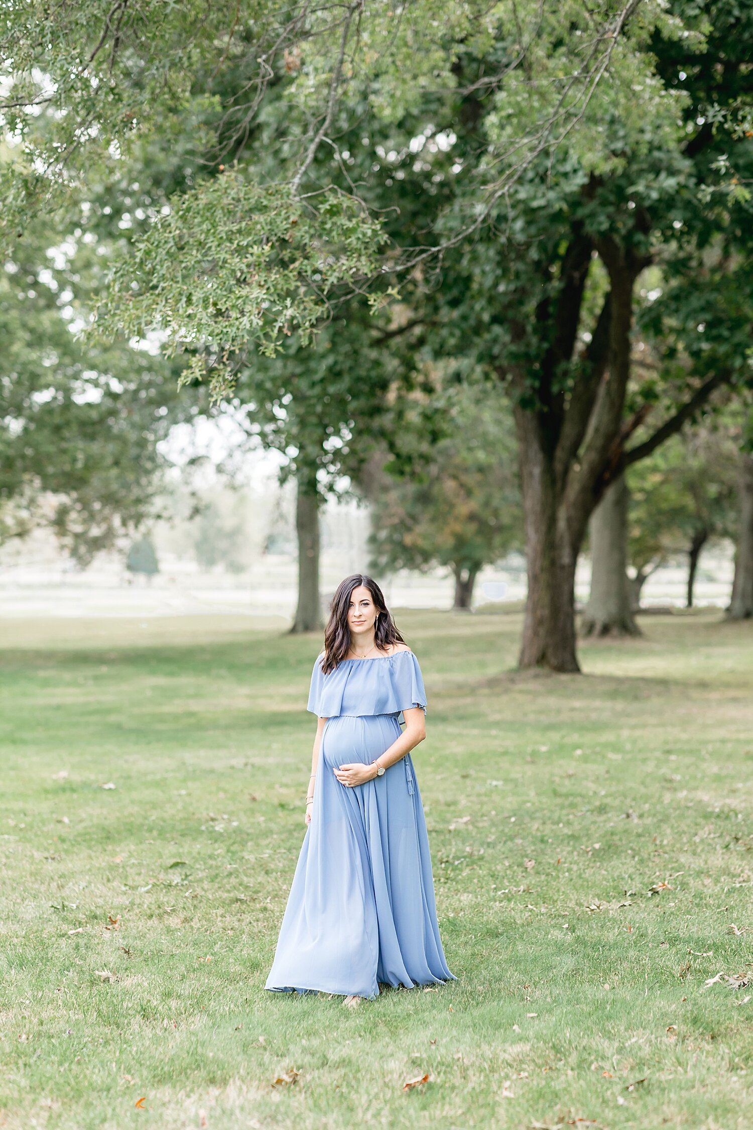 Mama during her maternity session in a long blue dress at Sherwood Island Park in Westport, CT. Photos by Kristin Wood Photography.