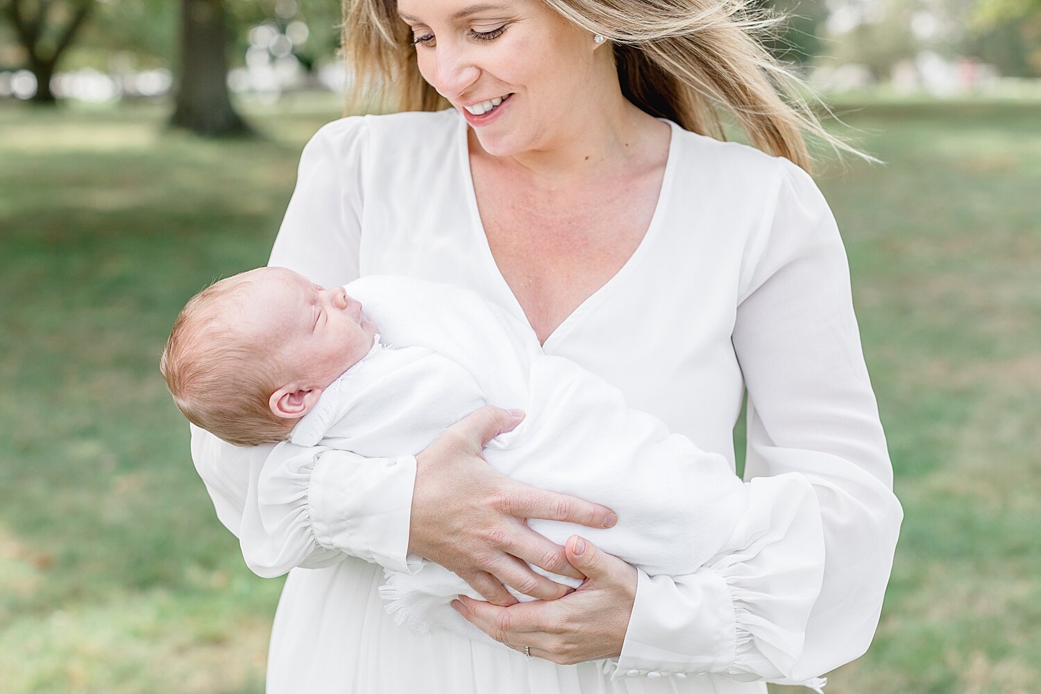 Mom with baby boy during newborn session. Both are wearing white. Photos by Kristin Wood Photography.