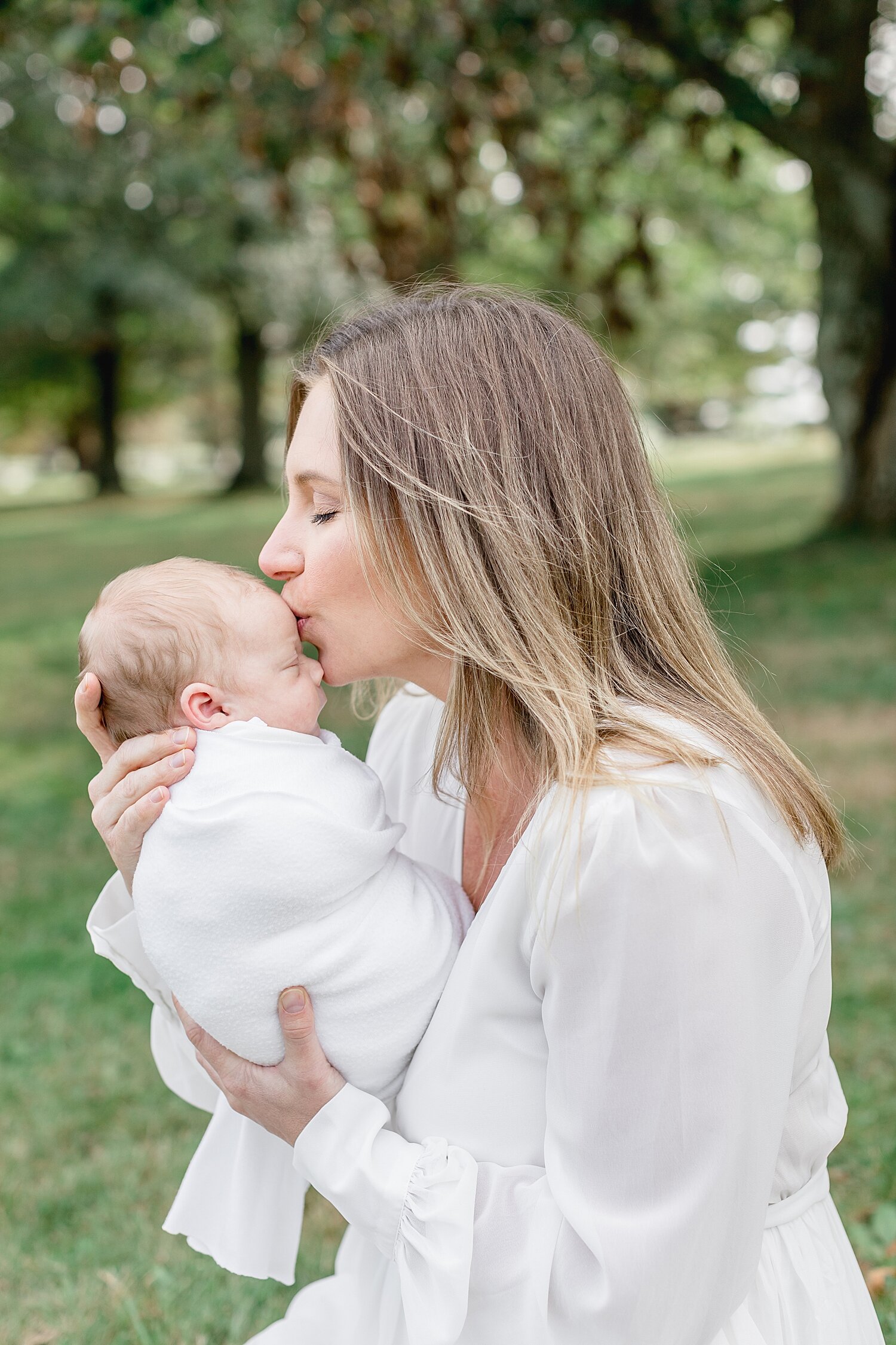 Mom giving baby boy a kiss | Kristin Wood Photography