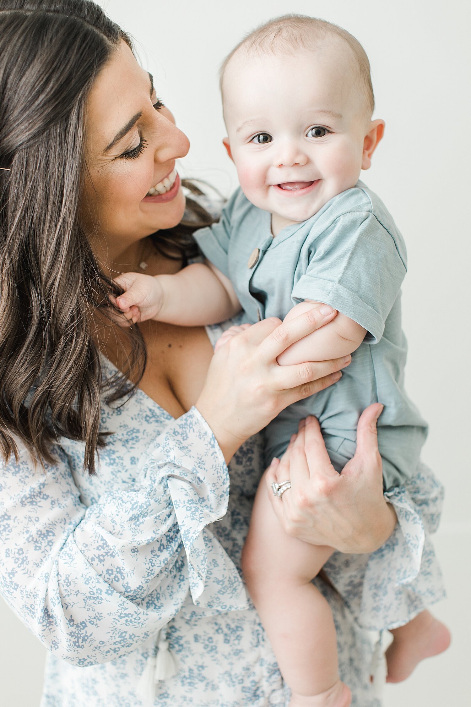 Mom smiling and looking at her son. Photos by Kristin Wood Photography.