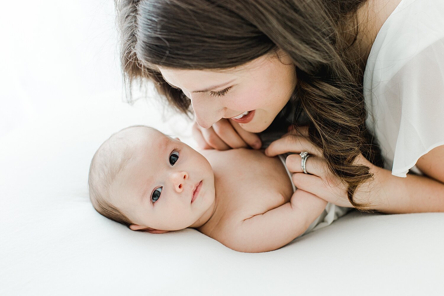 First time mom adoring her baby boy during newborn photoshoot with Kristin Wood Photography. 