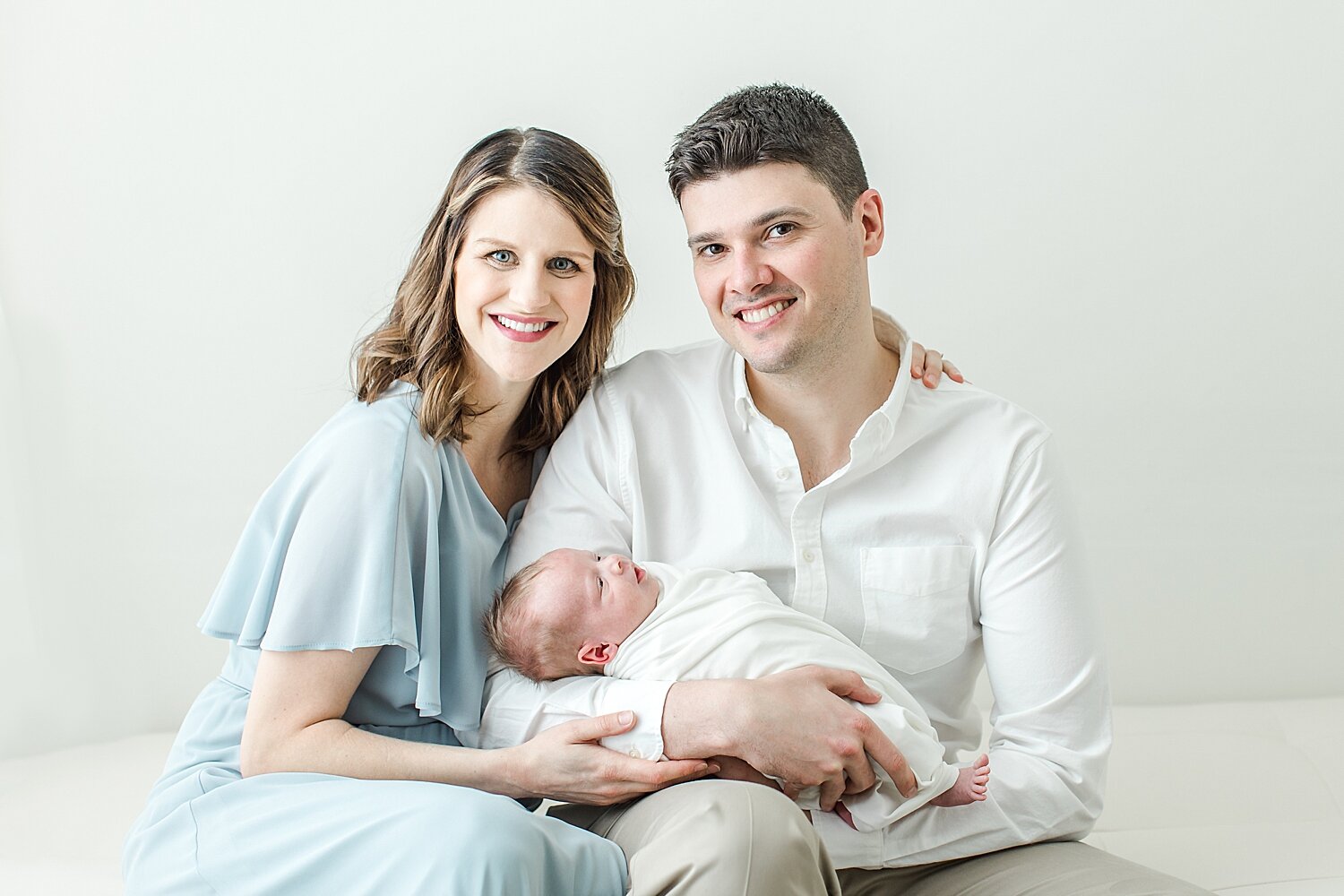 First time parents with baby boy. Photos by Kristin Wood Photography, a studio newborn baby photographer in Fairfield County, Connecticut.