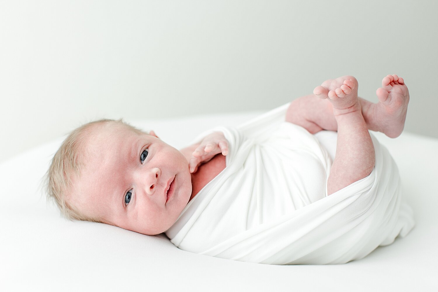 Newborn awake for photoshoot looking right at the camera. Photos by CT Newborn Photographer, Kristin Wood Photography.