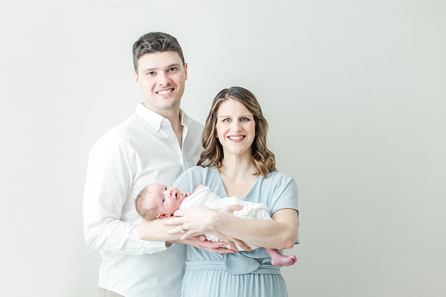 First time parents with baby boy. Photos by Kristin Wood Photography, a studio newborn baby photographer in Fairfield County, Connecticut.