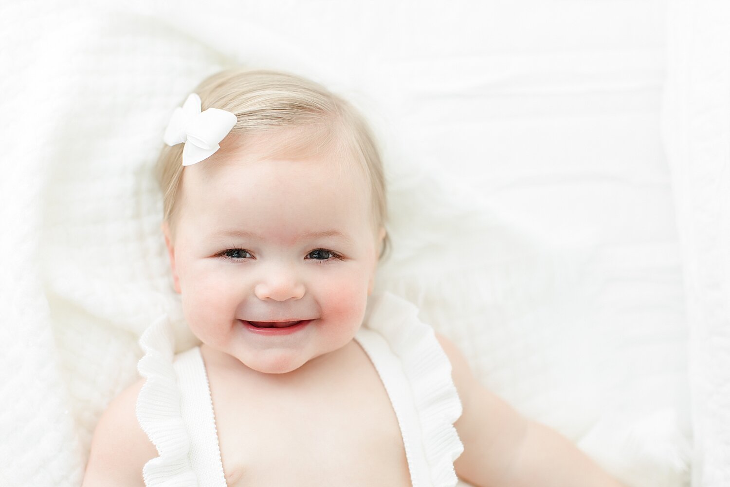 Baby girl laughing and so happy for photos with Kristin Wood Photography in Darien, CT.