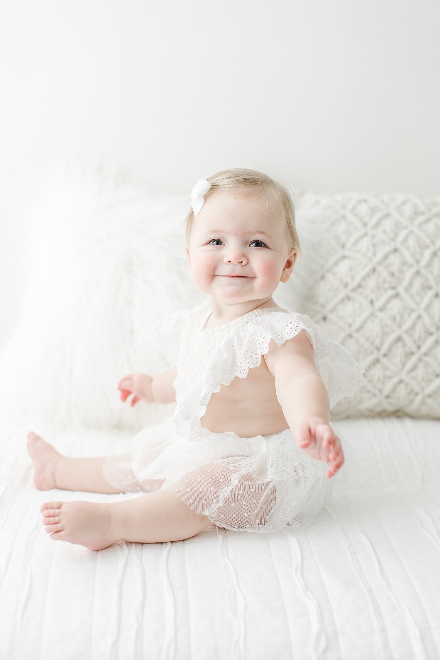 Baby girl smiling for her first birthday session with Kristin Wood Photography in Darien, CT.