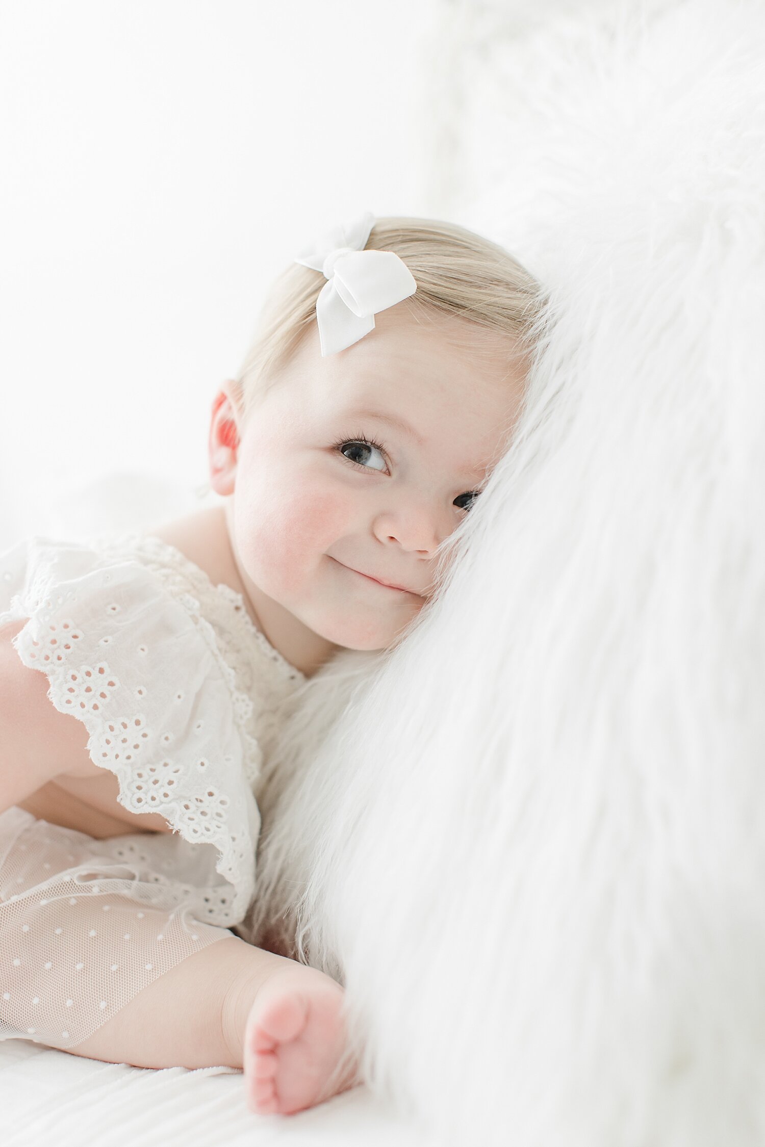 Sweet moment of little girl during first birthday photoshoot with Kristin Wood Photography. 