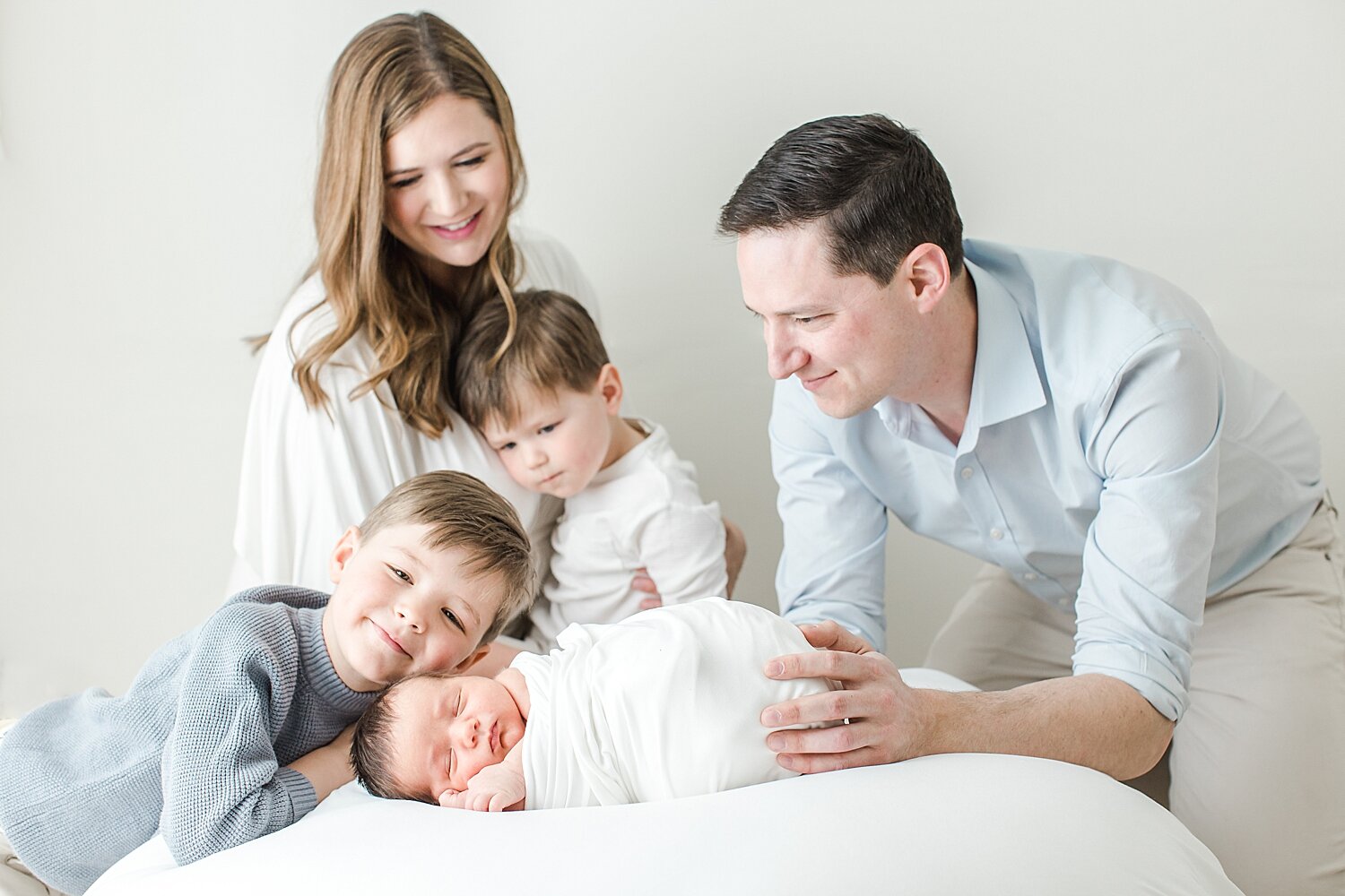 Newborn session with parents and three boys. Photo by Kristin Wood Photography.