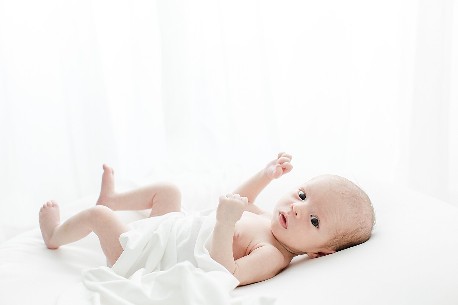 Baby boy wide awake during newborn session with Kristin Wood Photography.
