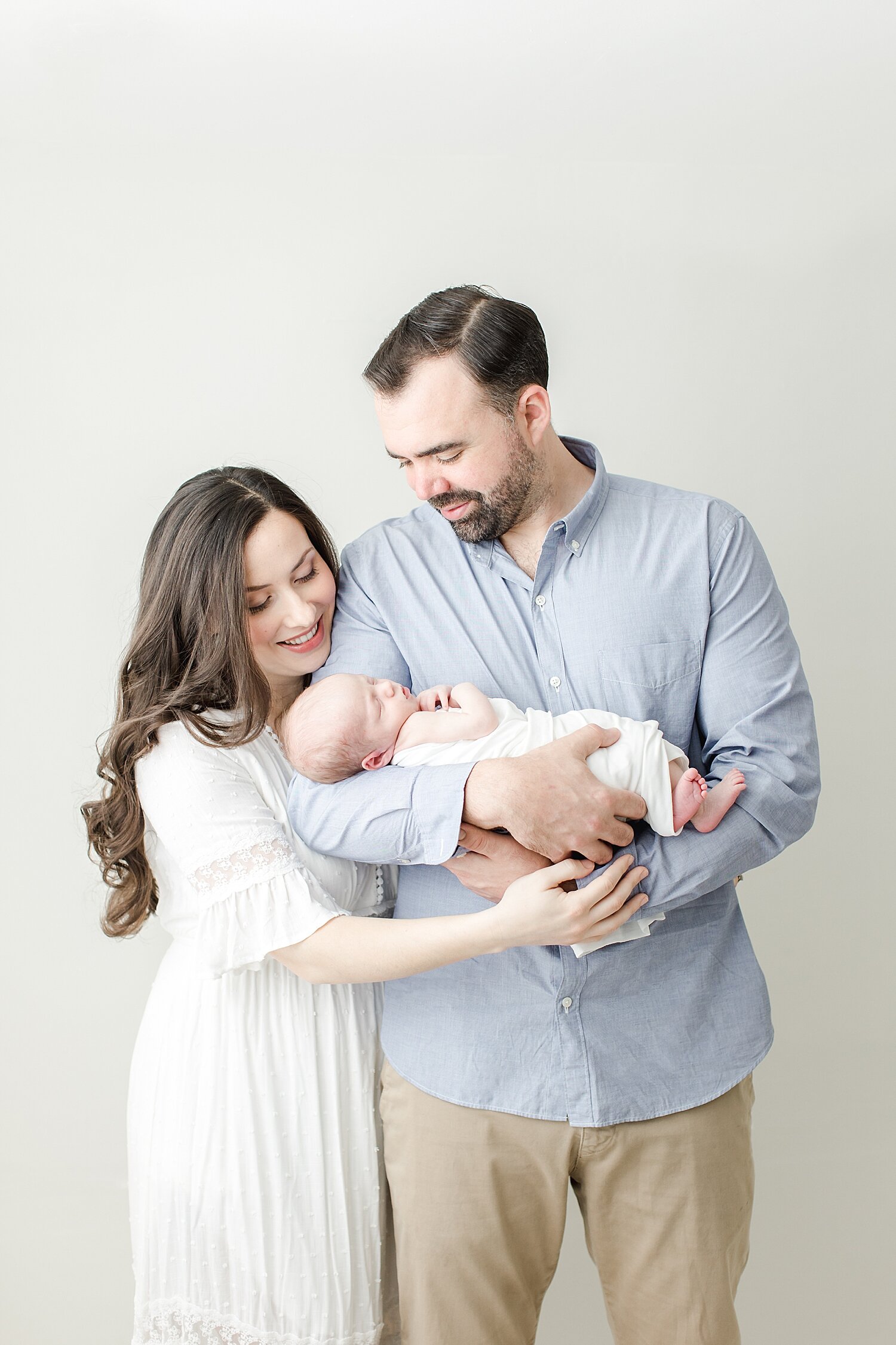 First-time parents looking at their newborn son. Photo by Kristin Wood Photography.