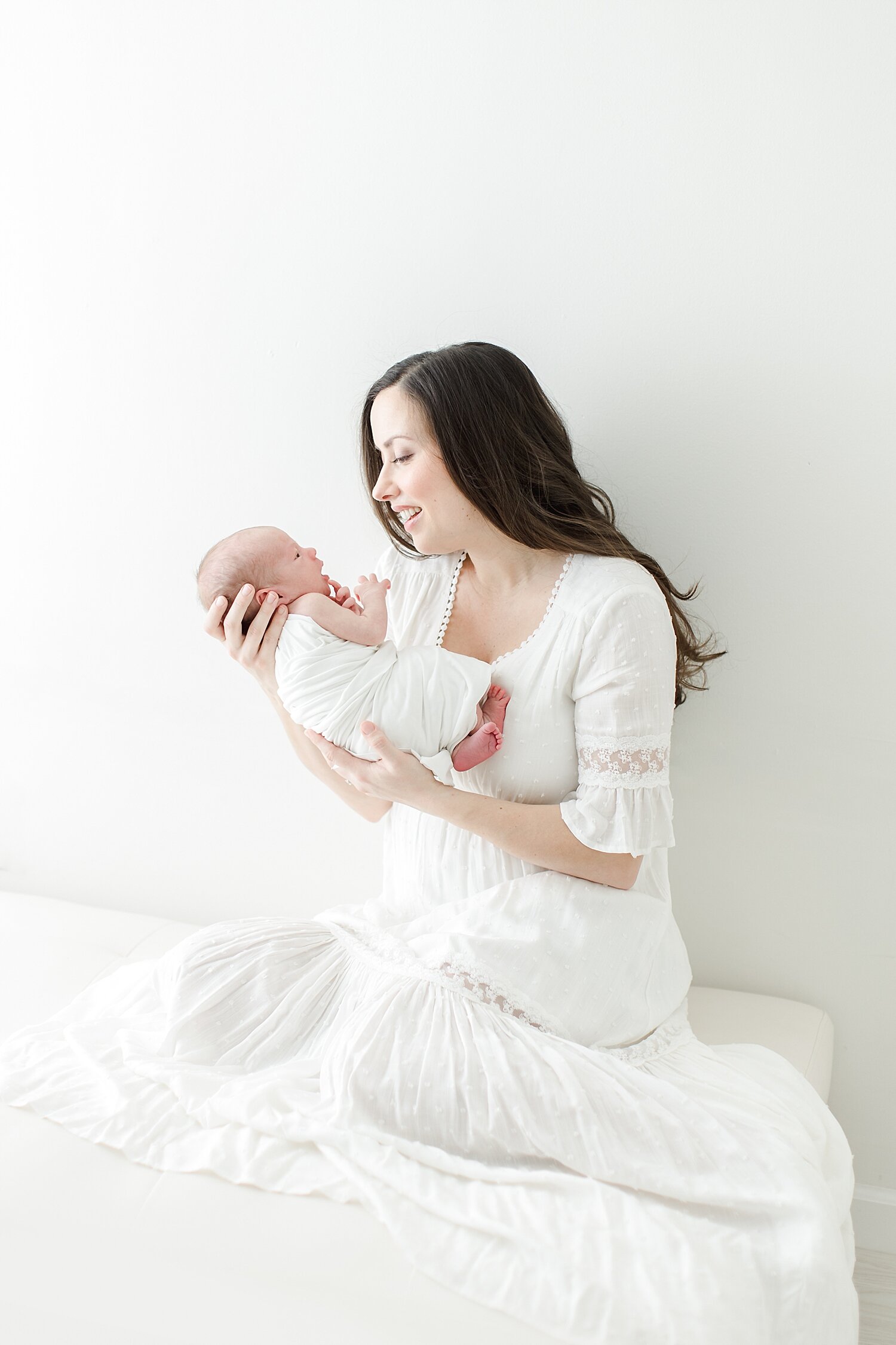 Newborn photo of mom and baby boy in studio. Photo by Kristin Wood Photography.