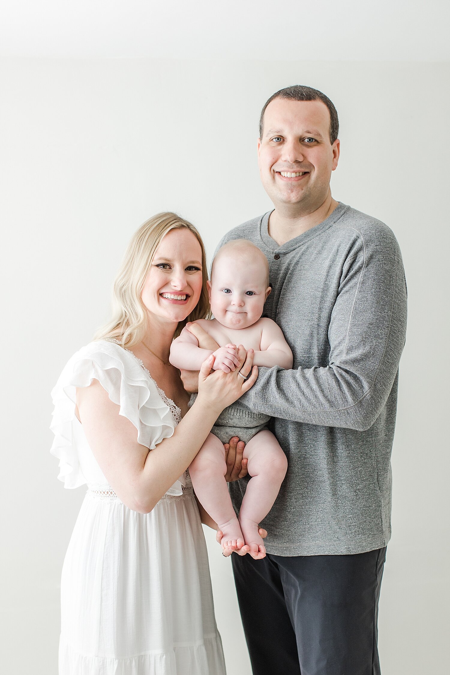 Family portrait during studio milestone session for 8 month old baby boy. Photo by CT Newborn and Family Photographer, Kristin Wood Photography.