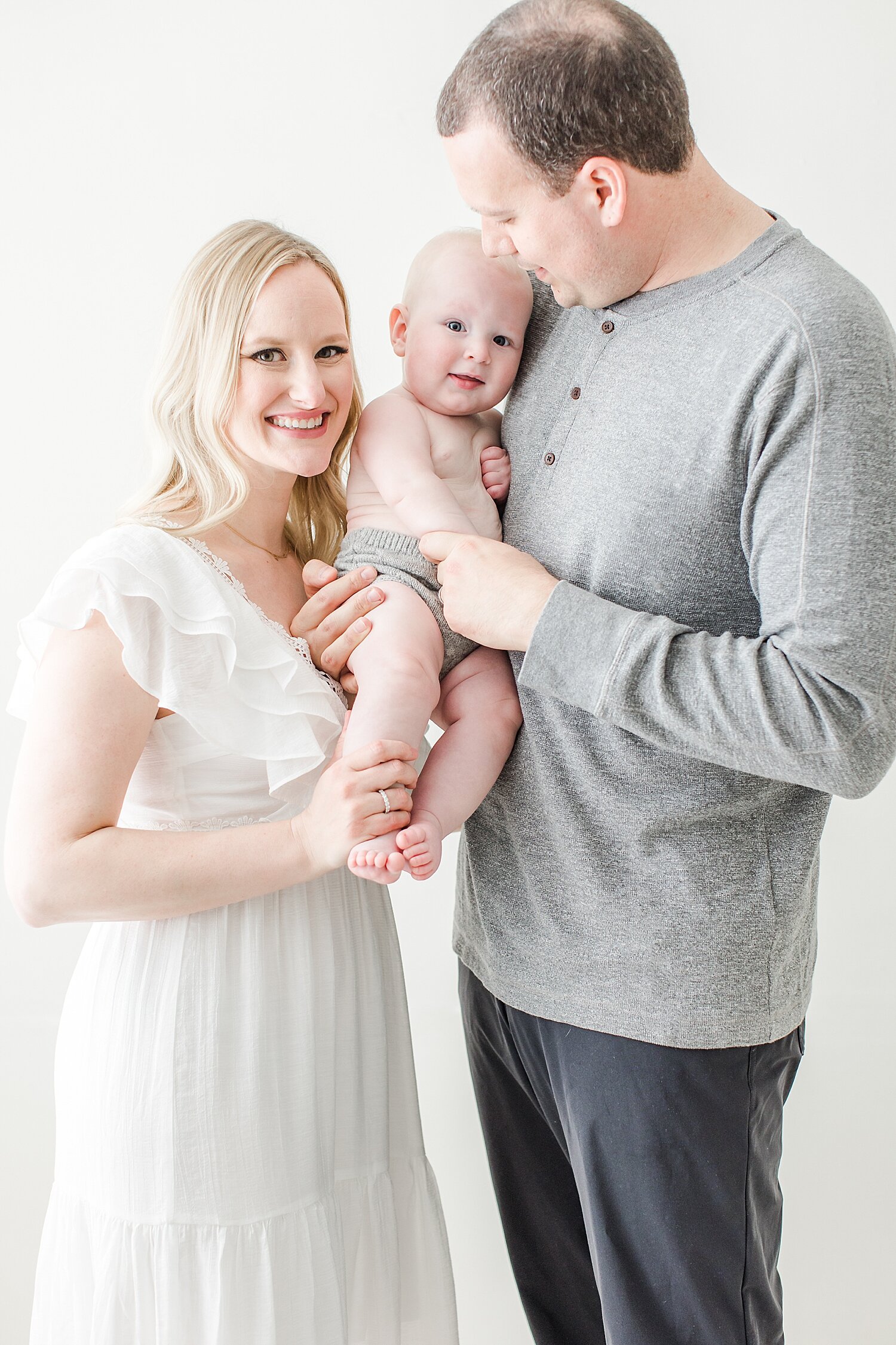 Family portrait during studio milestone session for 8 month old baby boy. Photo by CT Newborn and Family Photographer, Kristin Wood Photography.