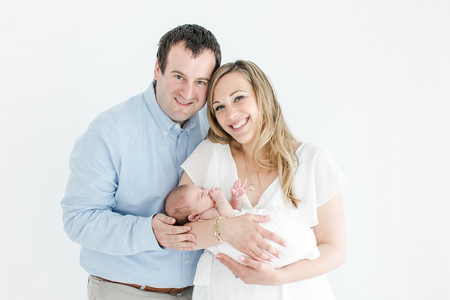 Mom and Dad with their baby girl. Photo by Kristin Wood Photography.