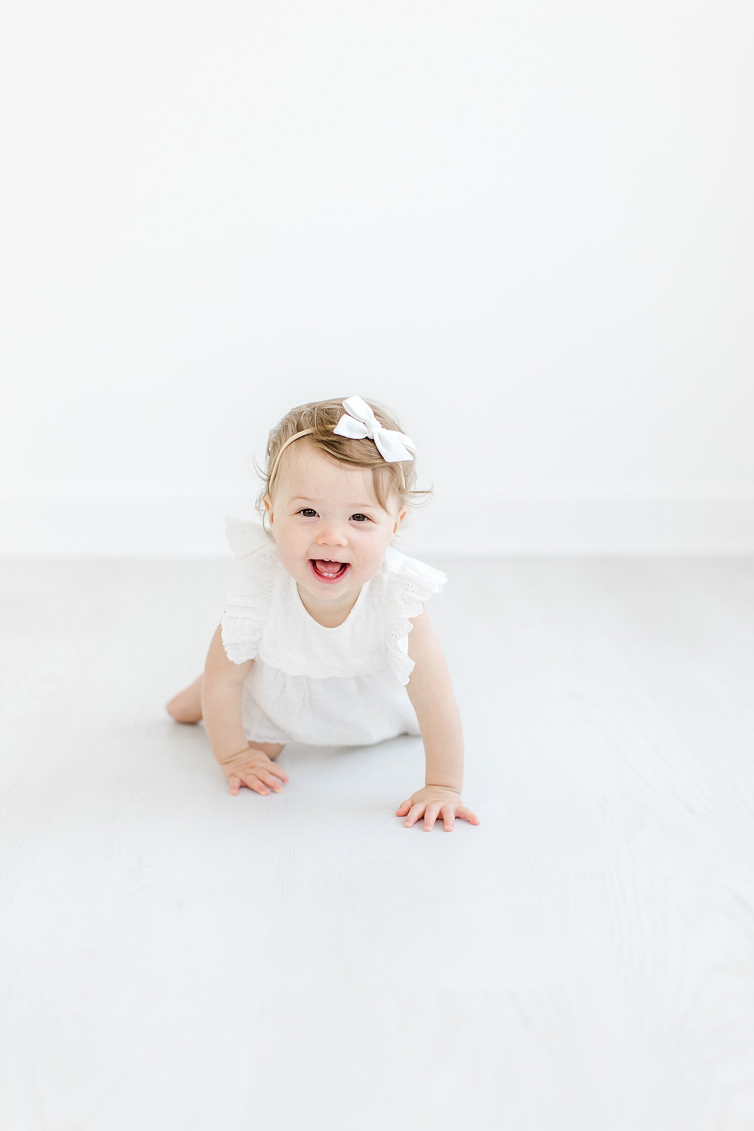 One-year-old crawling during first birthday photoshoot. Photo by Kristin Wood Photography.