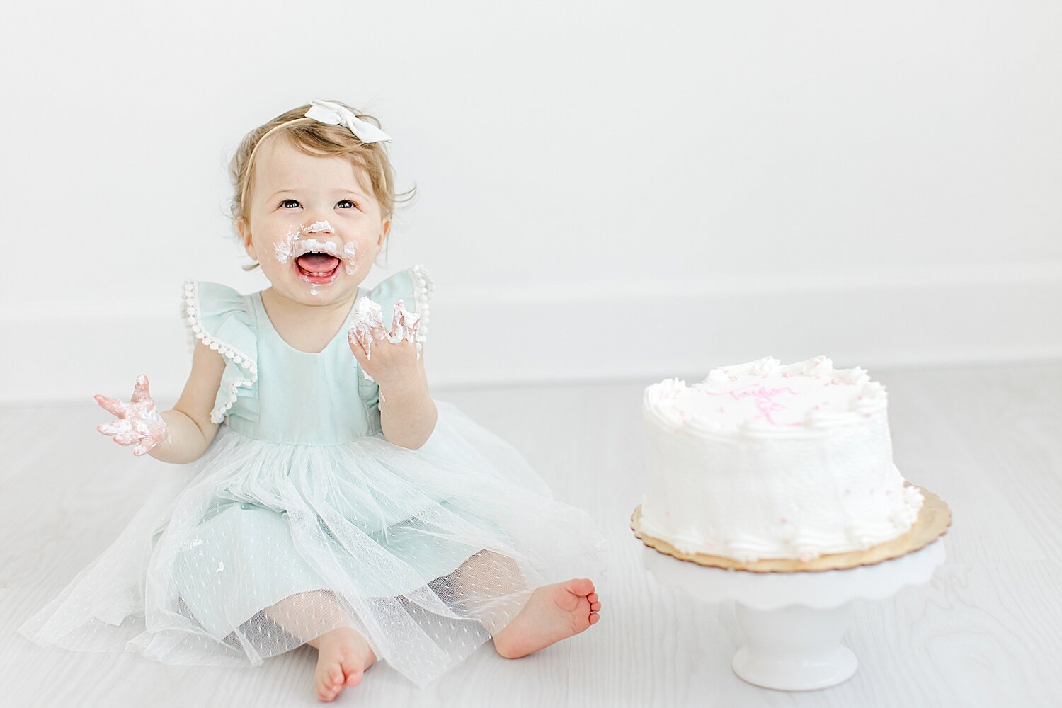 Baby girl first birthday cake smash in Westport studio. Photo by Kristin Wood Photography.