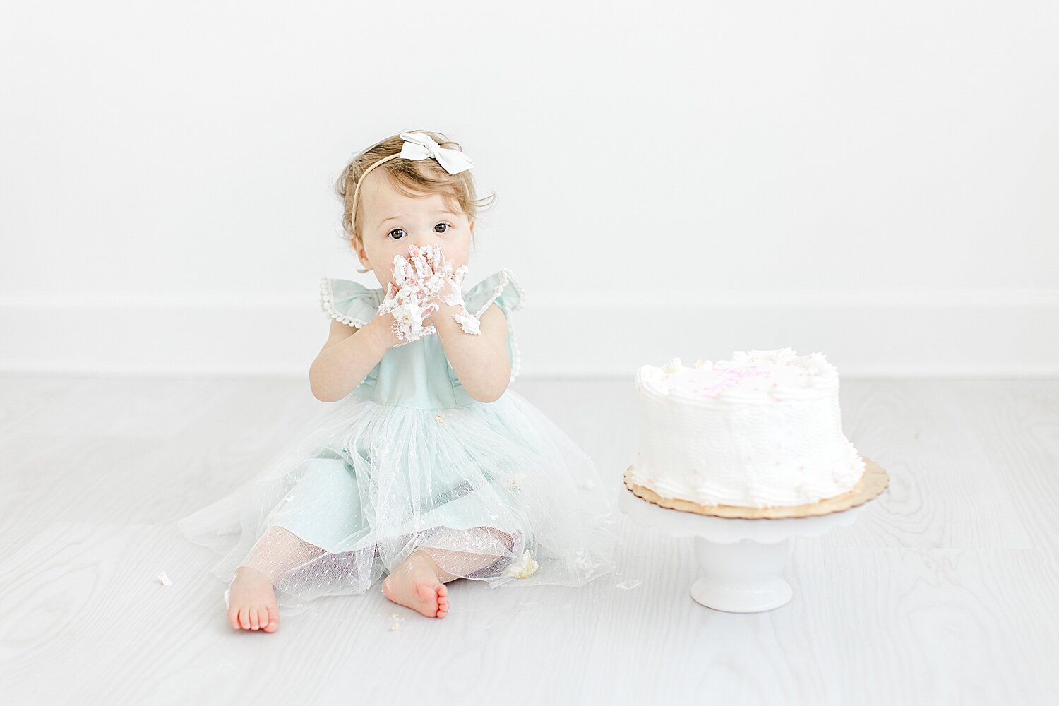 First birthday cake smash session with little girl. Photo by Kristin Wood Photography.