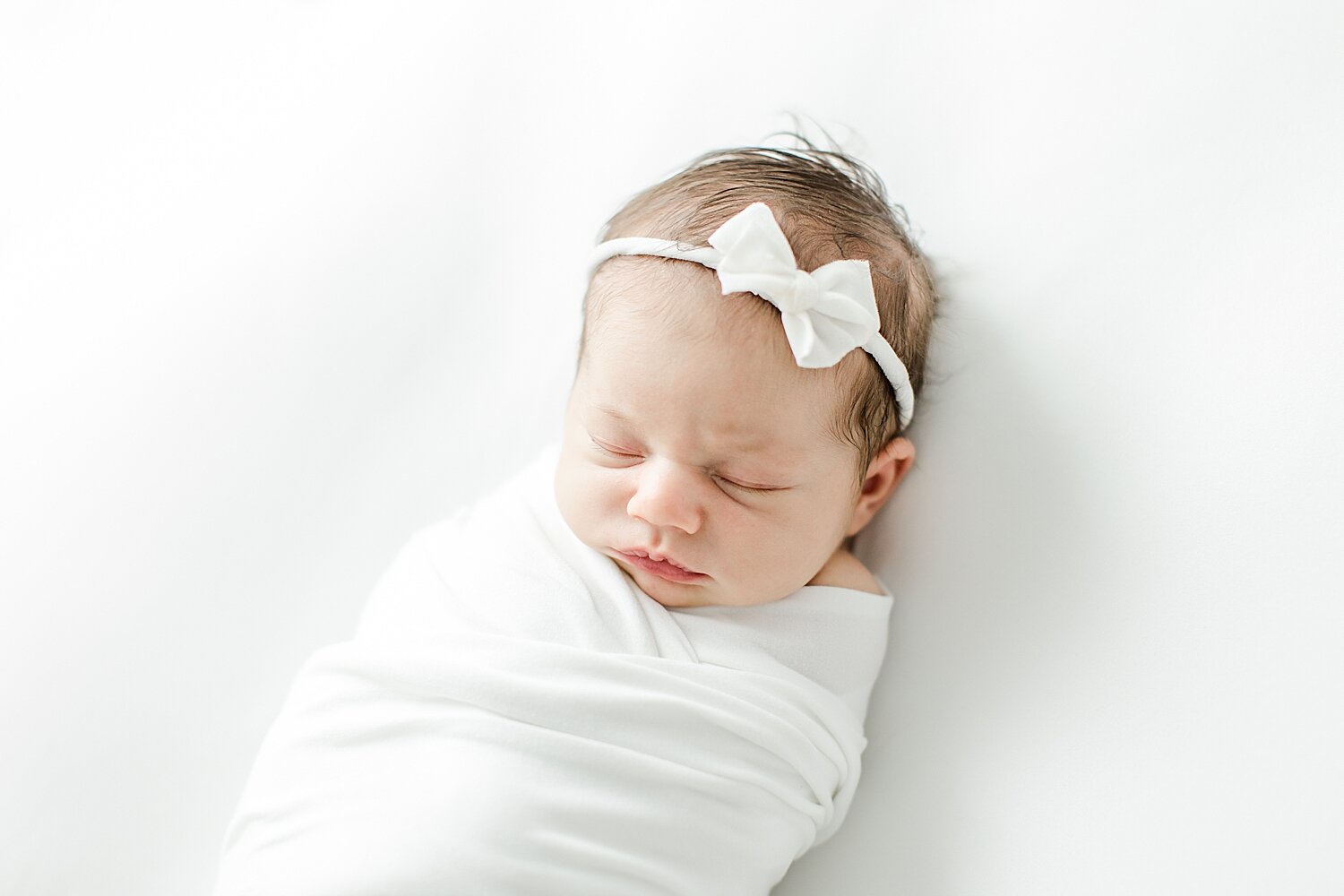 Classic newborn portrait in all white with Kristin Wood Photography in Westport, CT.