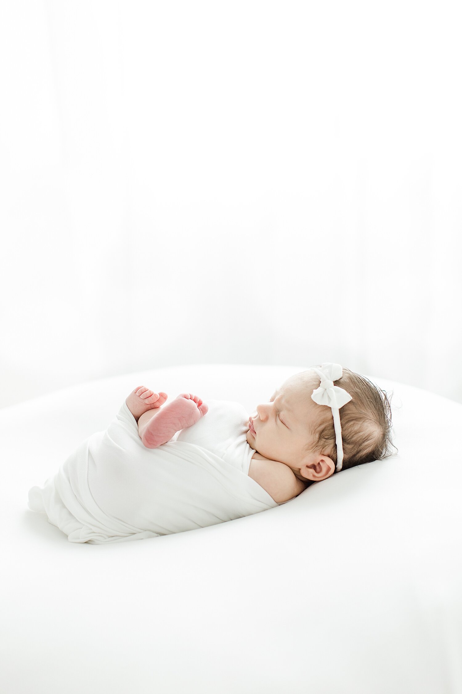 Classic newborn portrait in all white with Kristin Wood Photography in Westport, CT.