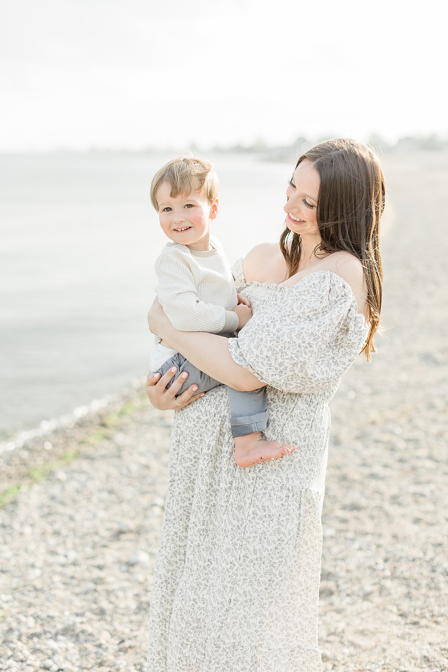 Mom holding her son during maternity session with baby #2. Photo by Kristin Wood Photography.
