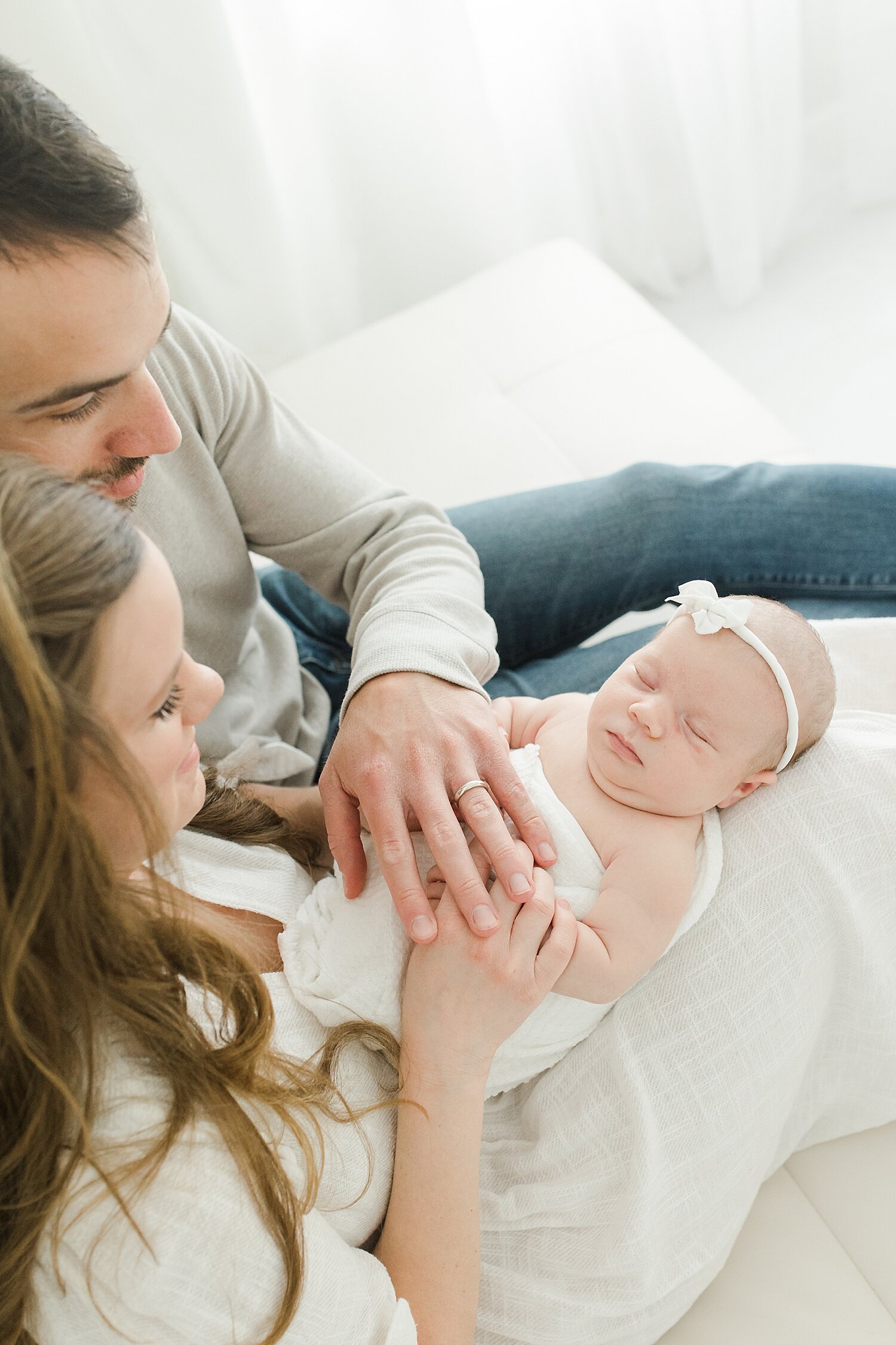 Mom and Dad holding their newborn daughter | Kristin Wood Photography