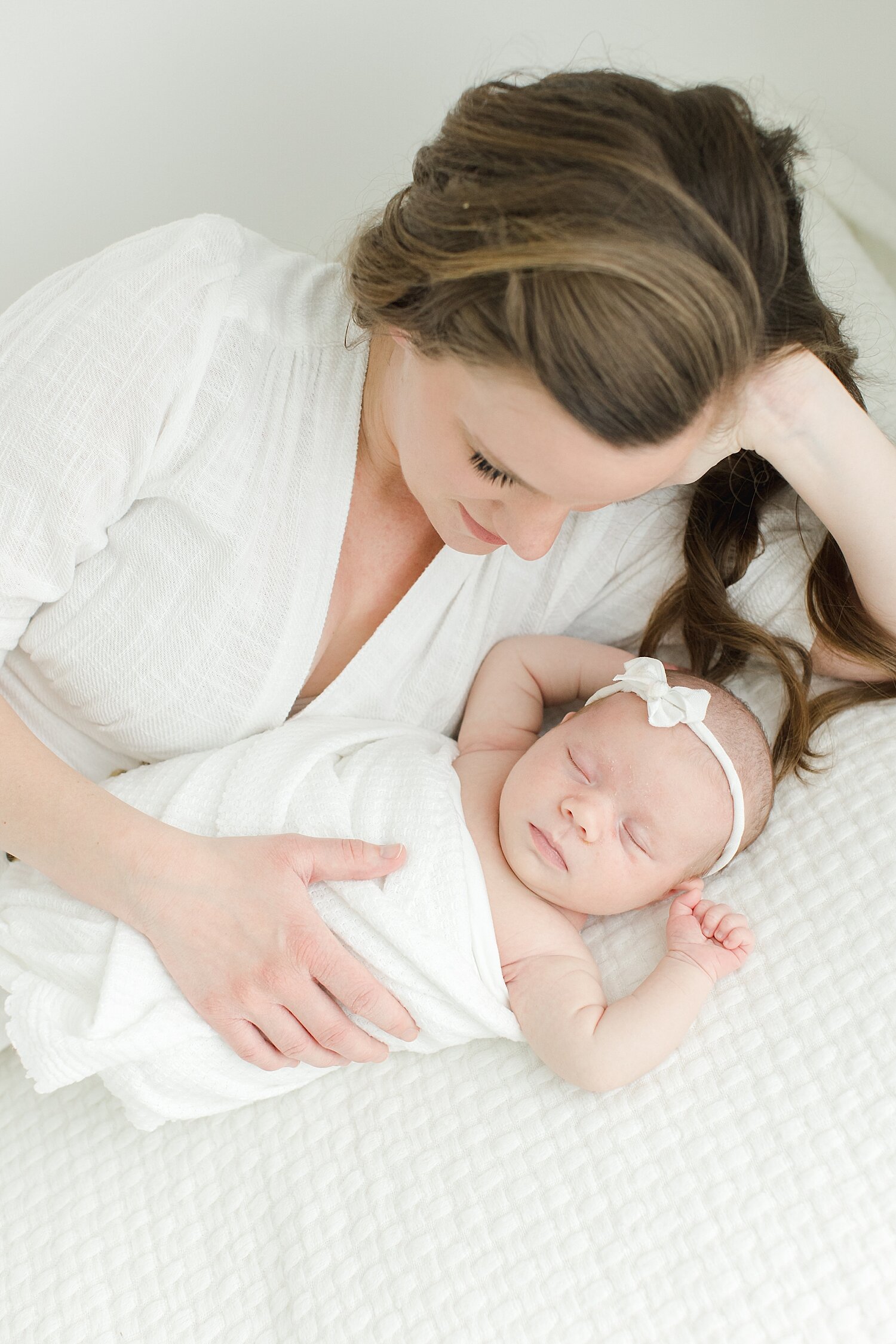 Mom laying with baby girl in studio in Westport, CT | Photo by Kristin Wood Photography