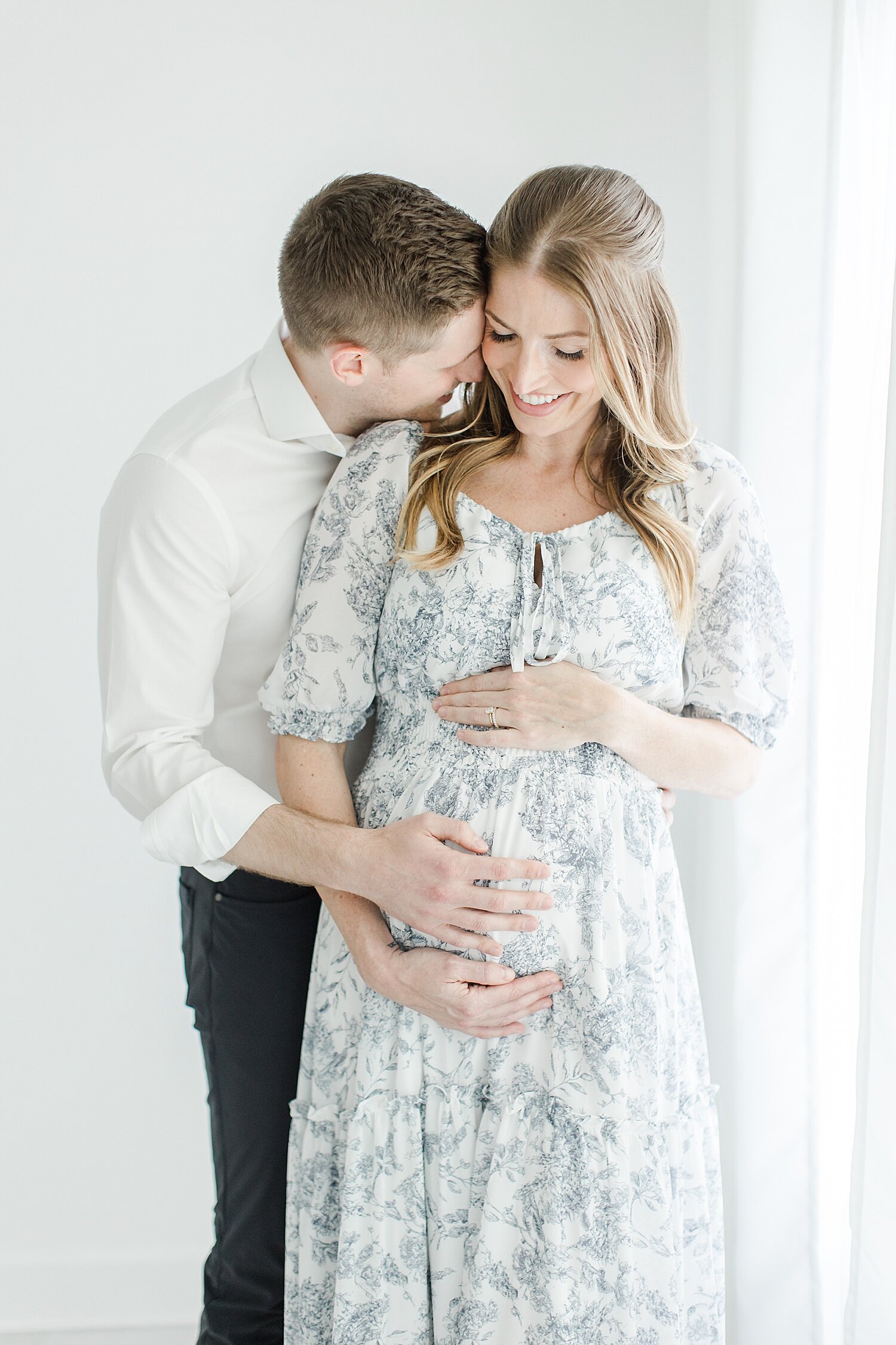 Sweet moment between Mom and Dad for maternity photos with Kristin Wood Photography.