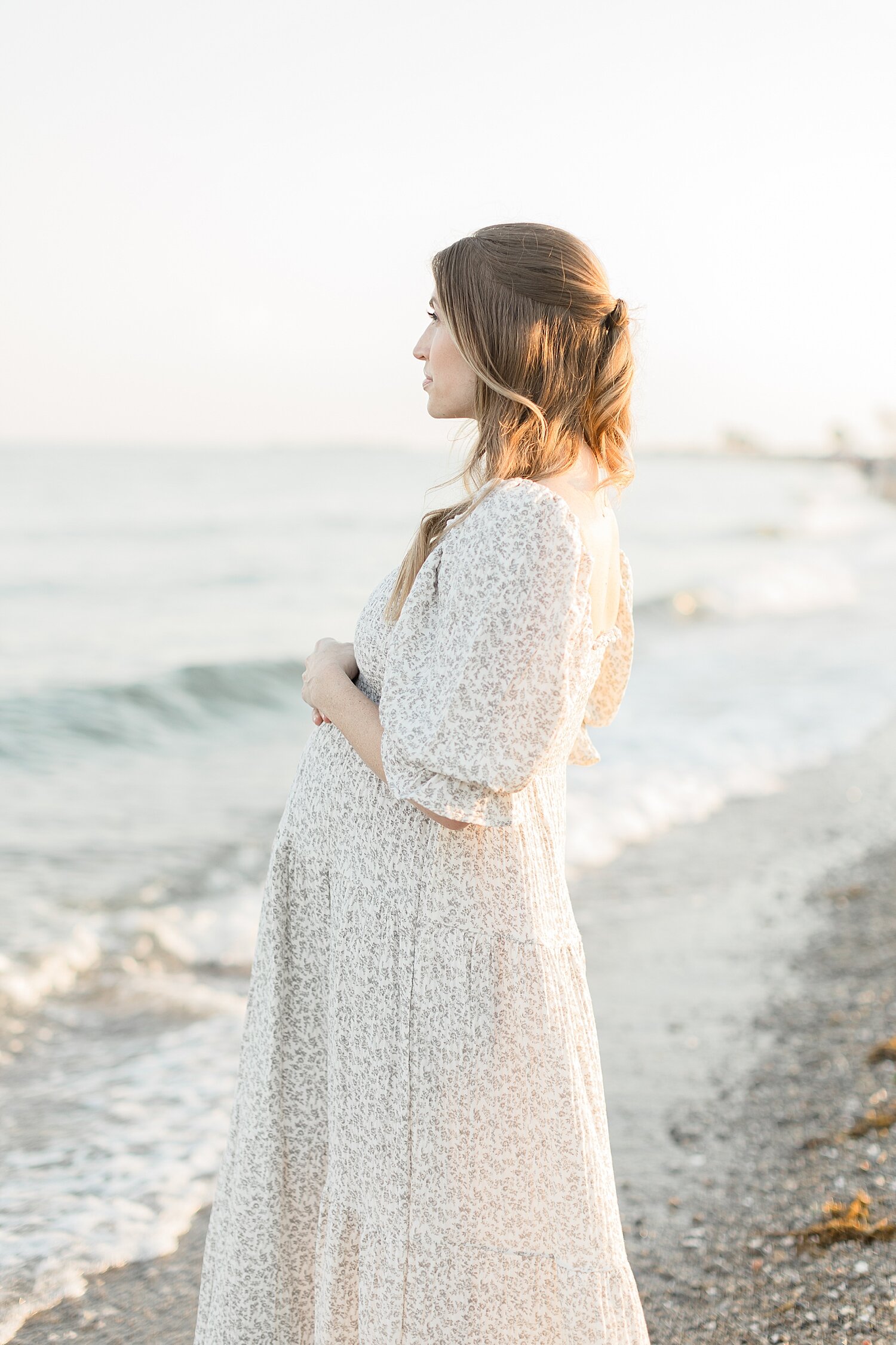 Pregnant mom looking out over the water in Westport, CT | Kristin Wood Photography