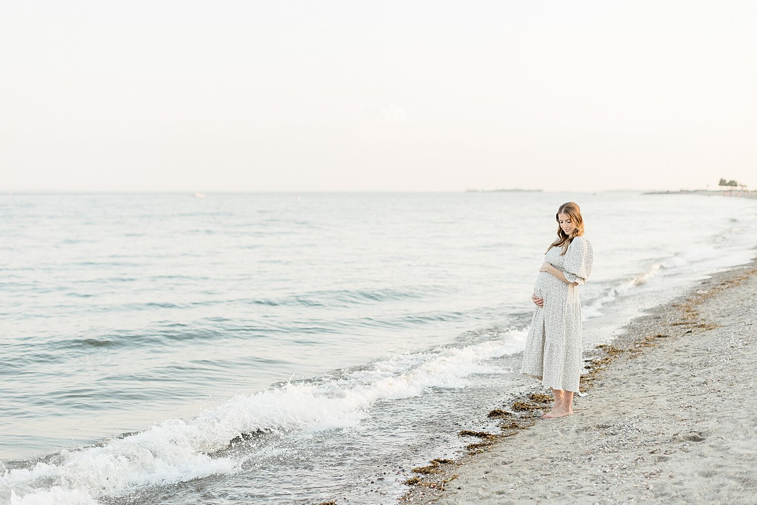 Mom on the beach in Westport for maternity photos with Kristin Wood Photography.